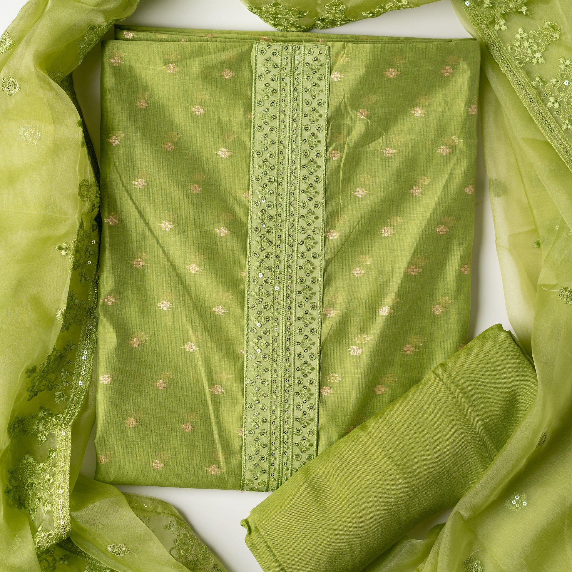 parrot green color Beautiful chanderi silk dress material with embroidery and sequins work on neck line. It has jacquard weaving in golden threads all over the top. Tissue silk dupatta with elegant embroidery and sequins work all over dupatta and at the borders. Parrot green color cotton silk bottom  matching the top and dupatta.