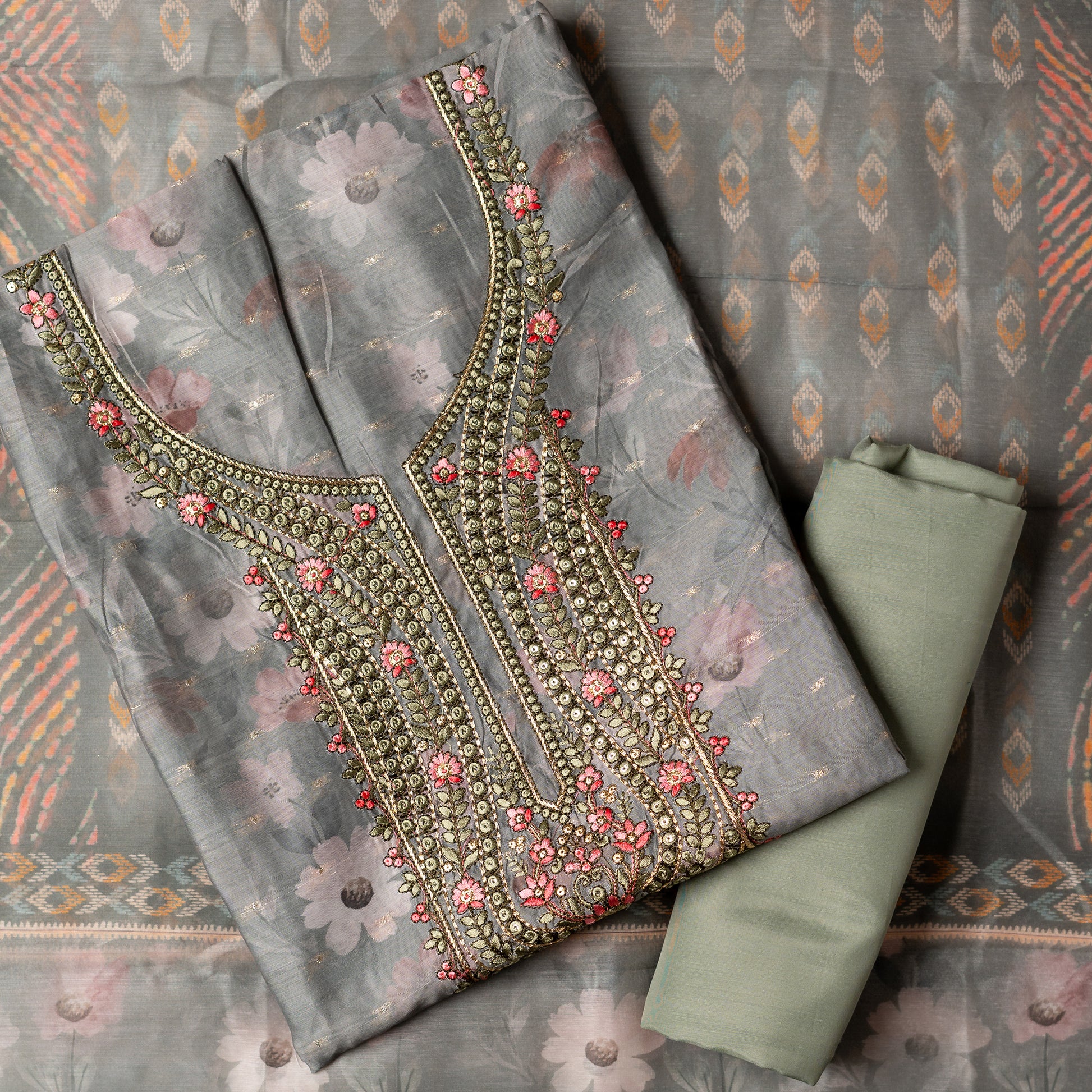 It's just awesome, pick any color of this design and we are sure you will love it the most. Beautiful embroidery work  in the neck. Sober floral prints and jacquard weaving in golden thread is giving the set a royal look. Silk dupatta with exact same design as the top with golden color border. Pastel green color bottom matching exactly as the top and dupatta.