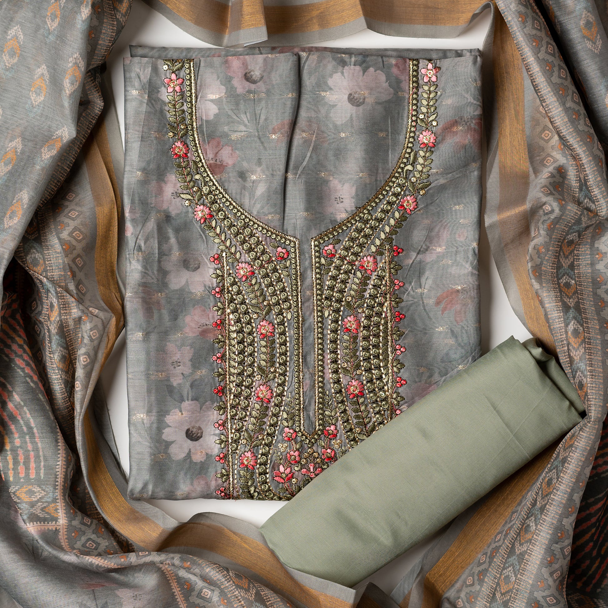 It's just awesome, pick any color of this design and we are sure you will love it the most. Beautiful embroidery work  in the neck. Sober floral prints and jacquard weaving in golden thread is giving the set a royal look. Silk dupatta with exact same design as the top with golden color border. Pastel green color bottom matching exactly as the top and dupatta.