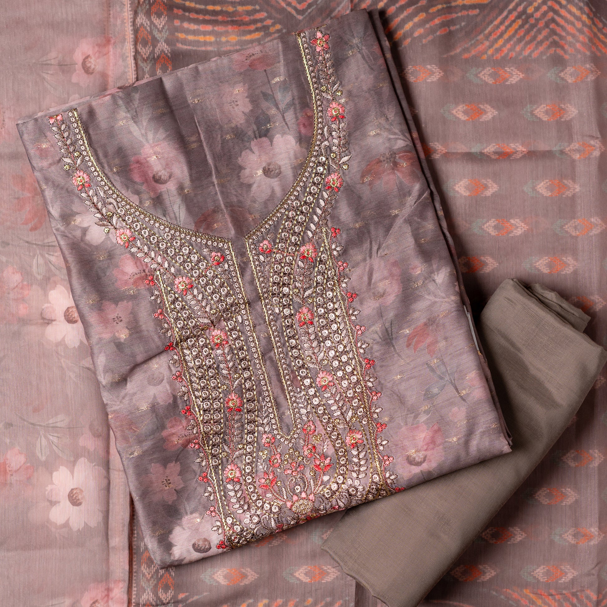 It's just awesome, pick any color of this design and we are sure you will love it the most. Beautiful embroidery work  in the neck. Sober floral prints and jacquard weaving in golden thread is giving the set a royal look. Silk dupatta with exact same design as the top with golden color border. Pastel wine color bottom matching exactly as the top and dupatta.