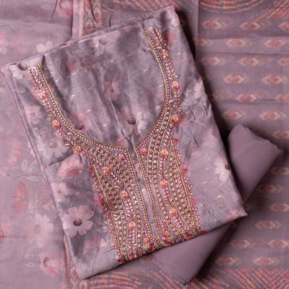 It's just awesome, pick any color of this design and we are sure you will love it the most. Beautiful embroidery work  in the neck. Sober floral prints and jacquard weaving in golden thread is giving the set a royal look. Silk dupatta with exact same design as the top with golden color border. Pastel purple color bottom matching exactly as the top and dupatta.