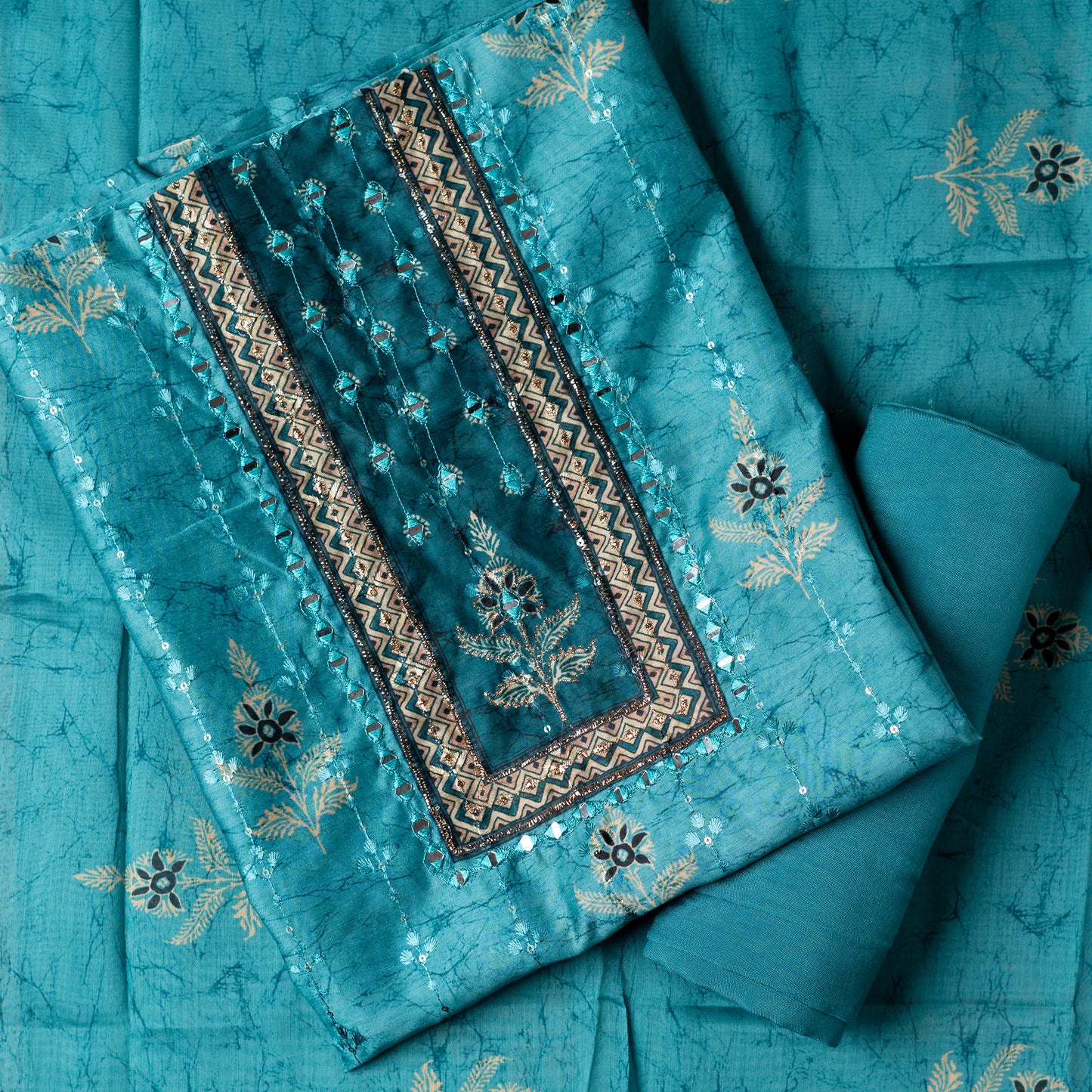 Chanderi silk dress material with print design, embroidery work, thread work and sequins work. It has zari and mirror work in neck area also. Silk dupatta with beautiful digital prints matching the top color. Cotton silk bottom same teal blue color as the top and dupatta. 