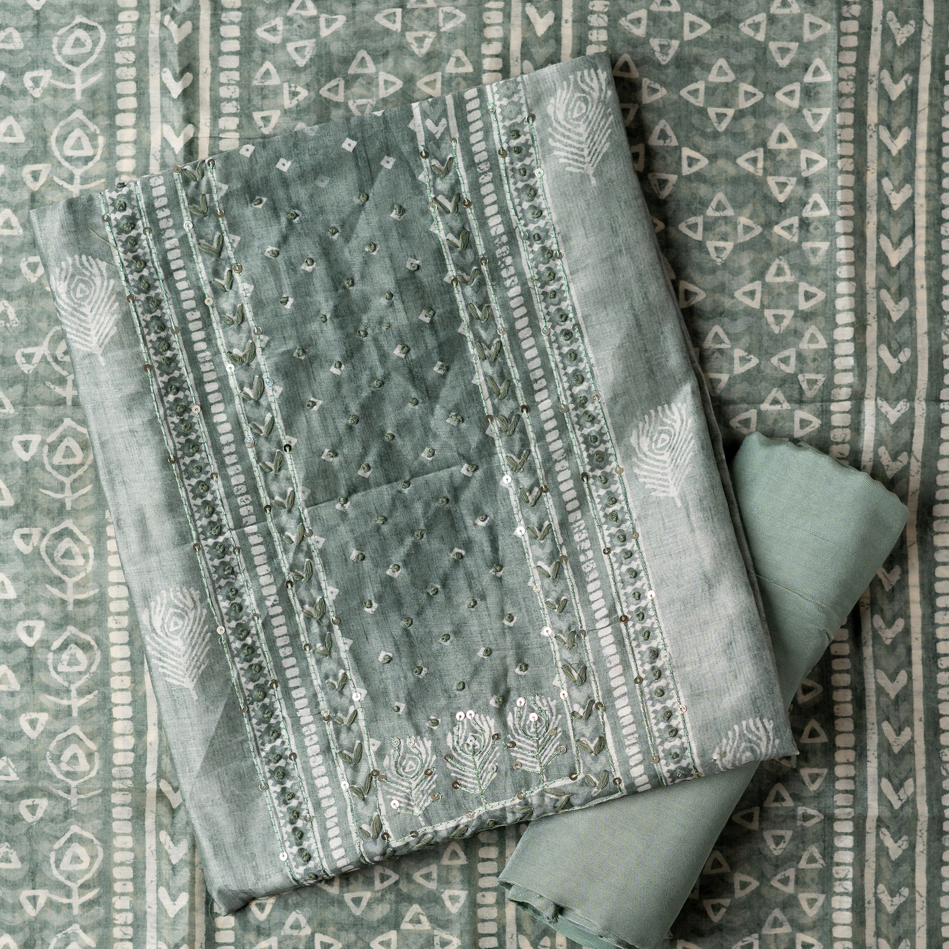 Chanderi silk dress material with thread work and and sequins work, the thread work is done with the same color thread of the top. Digital printed silk dupatta  with same color combination as top. Light green color cotton silk bottom, matching the top and dupatta color.