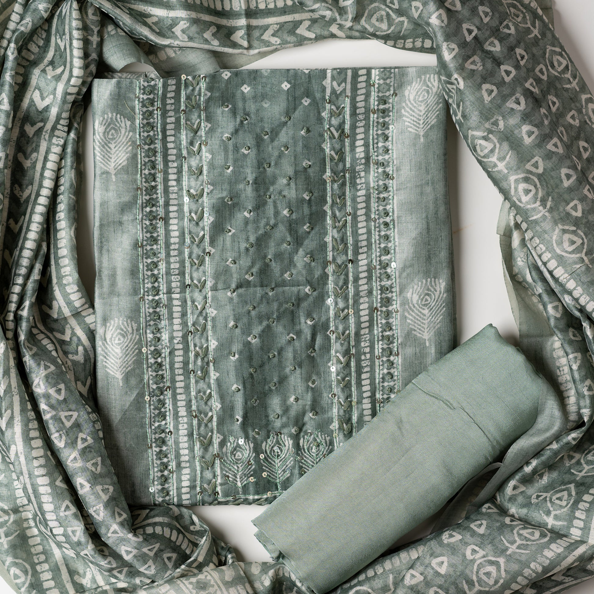 Chanderi silk dress material with thread work and and sequins work, the thread work is done with the same color thread of the top. Digital printed silk dupatta  with same color combination as top. Light green color cotton silk bottom, matching the top and dupatta color.