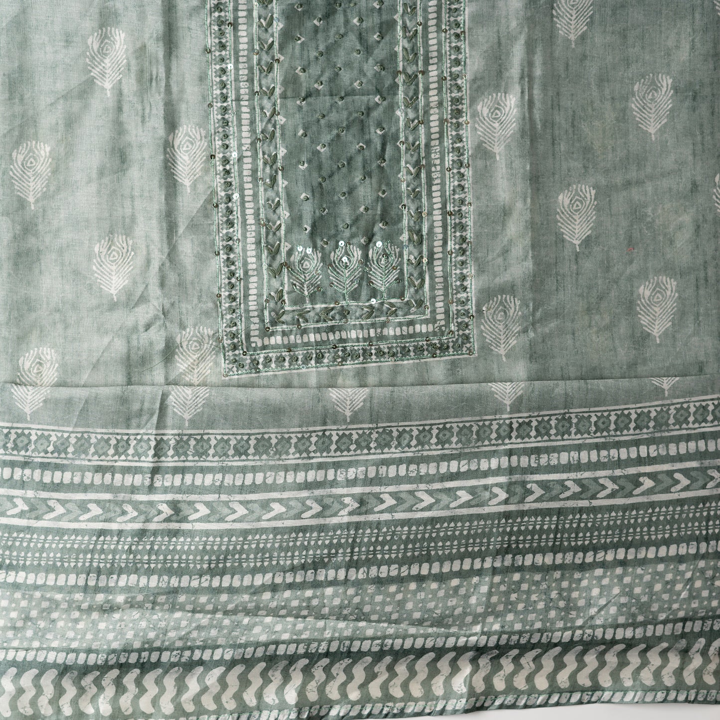 Chanderi silk dress material with thread work and and sequins work, the thread work is done with the same color thread of the top. 