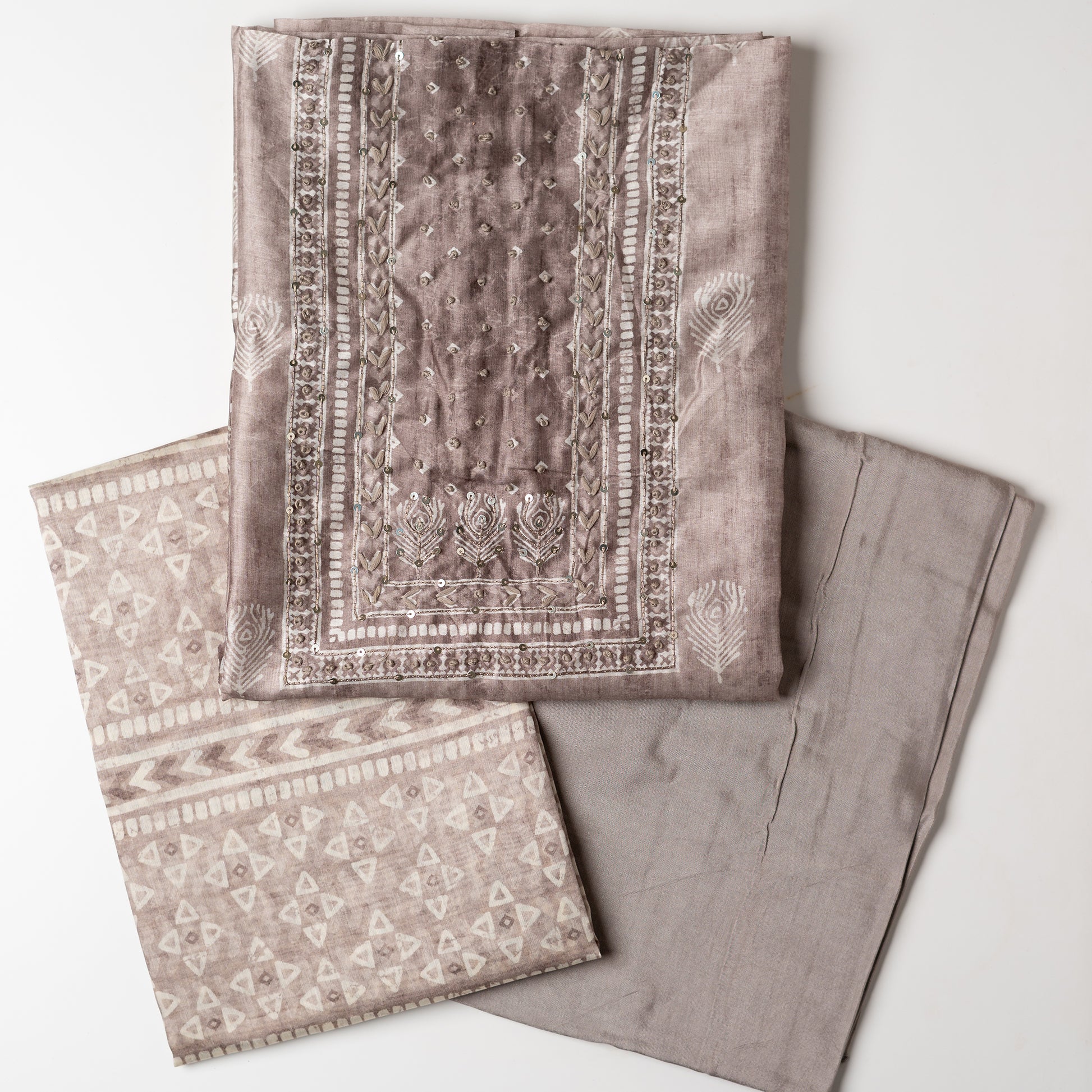 Chanderi silk dress material with thread work and and sequins work, the thread work is done with the same color thread of the top. Digital printed silk dupatta  with same color combination as top. Light brown color cotton silk bottom, matching the top and dupatta color.