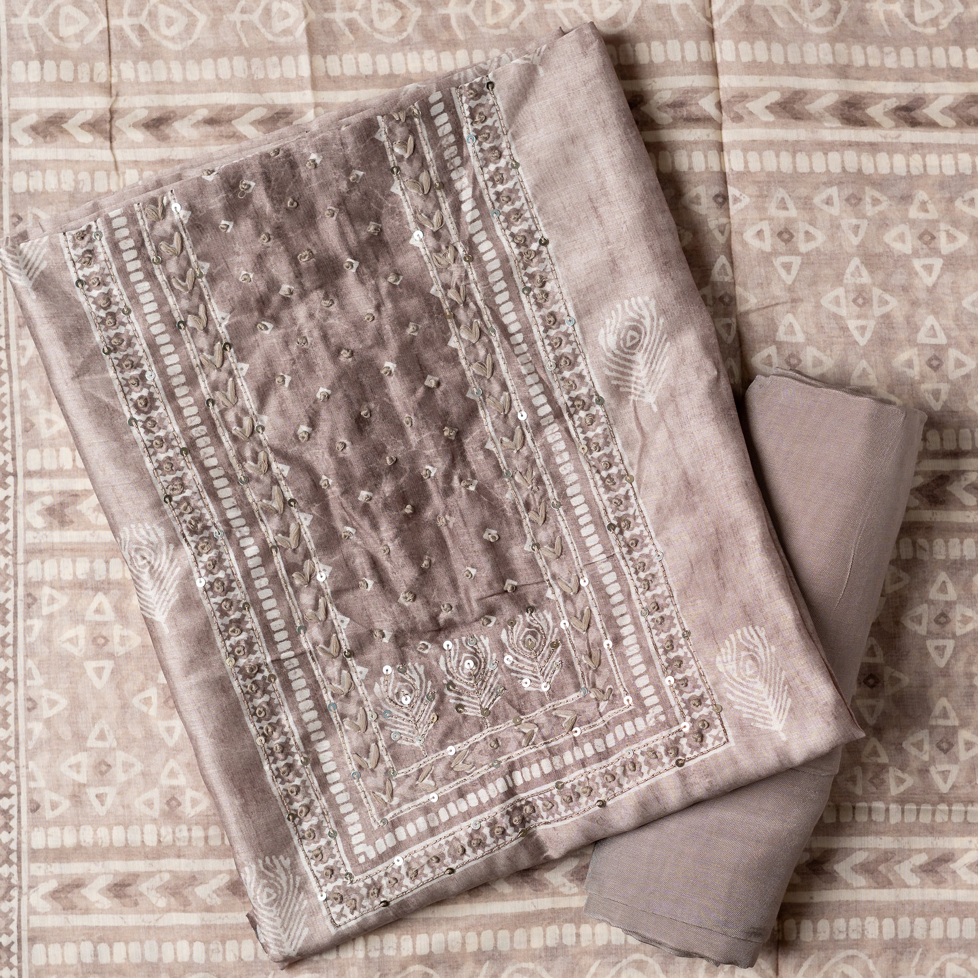 Chanderi silk dress material with thread work and and sequins work, the thread work is done with the same color thread of the top. Digital printed silk dupatta  with same color combination as top. Light brown color cotton silk bottom, matching the top and dupatta color.