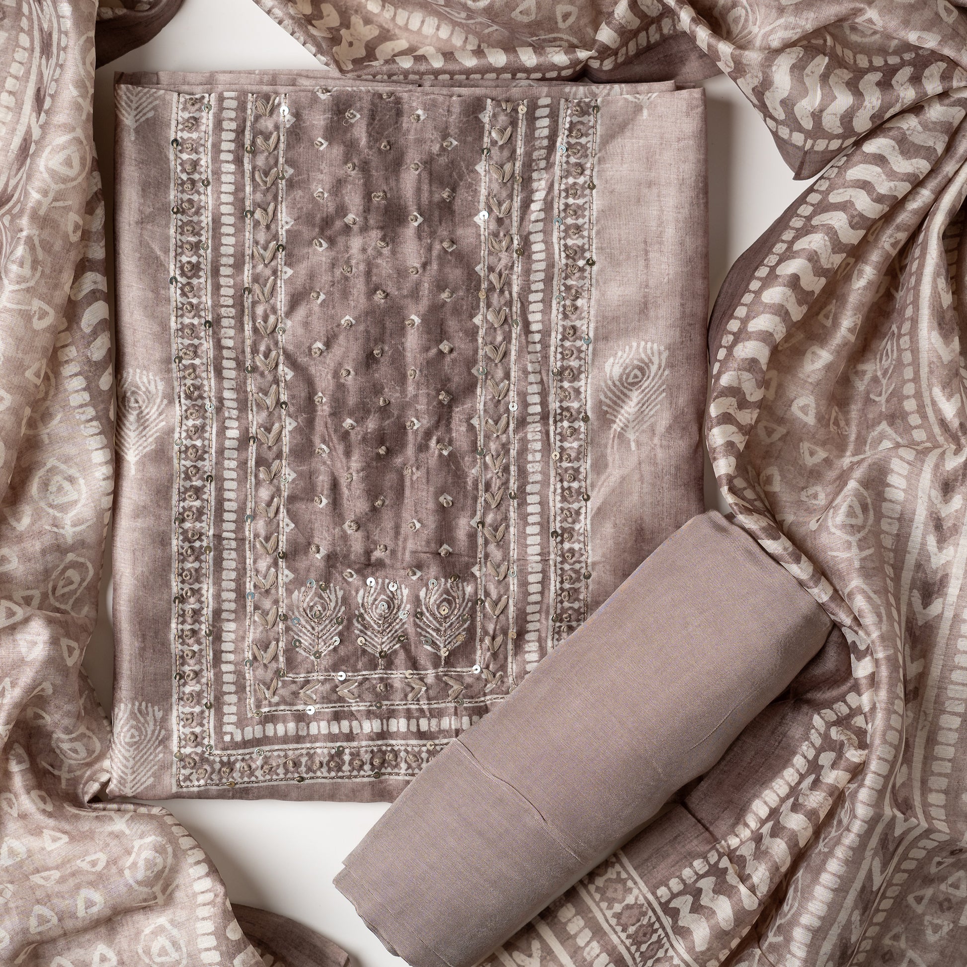 Chanderi silk dress material with thread work and and sequins work, the thread work is done with the same color thread of the top. Digital printed silk dupatta  with same color combination as top. Light brown color cotton silk bottom, matching the top and dupatta color.