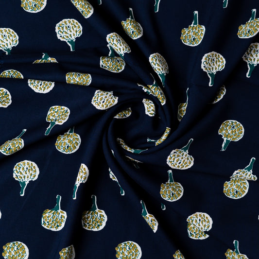 Blue color rayon fabric with white , navy blue and green color prints