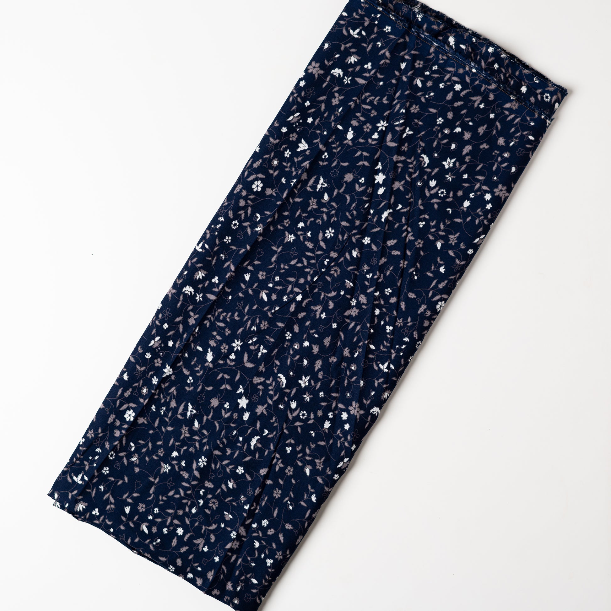 Navy blue color rayon fabric with white and grey color floral prints, this is a small print design elegant fabric