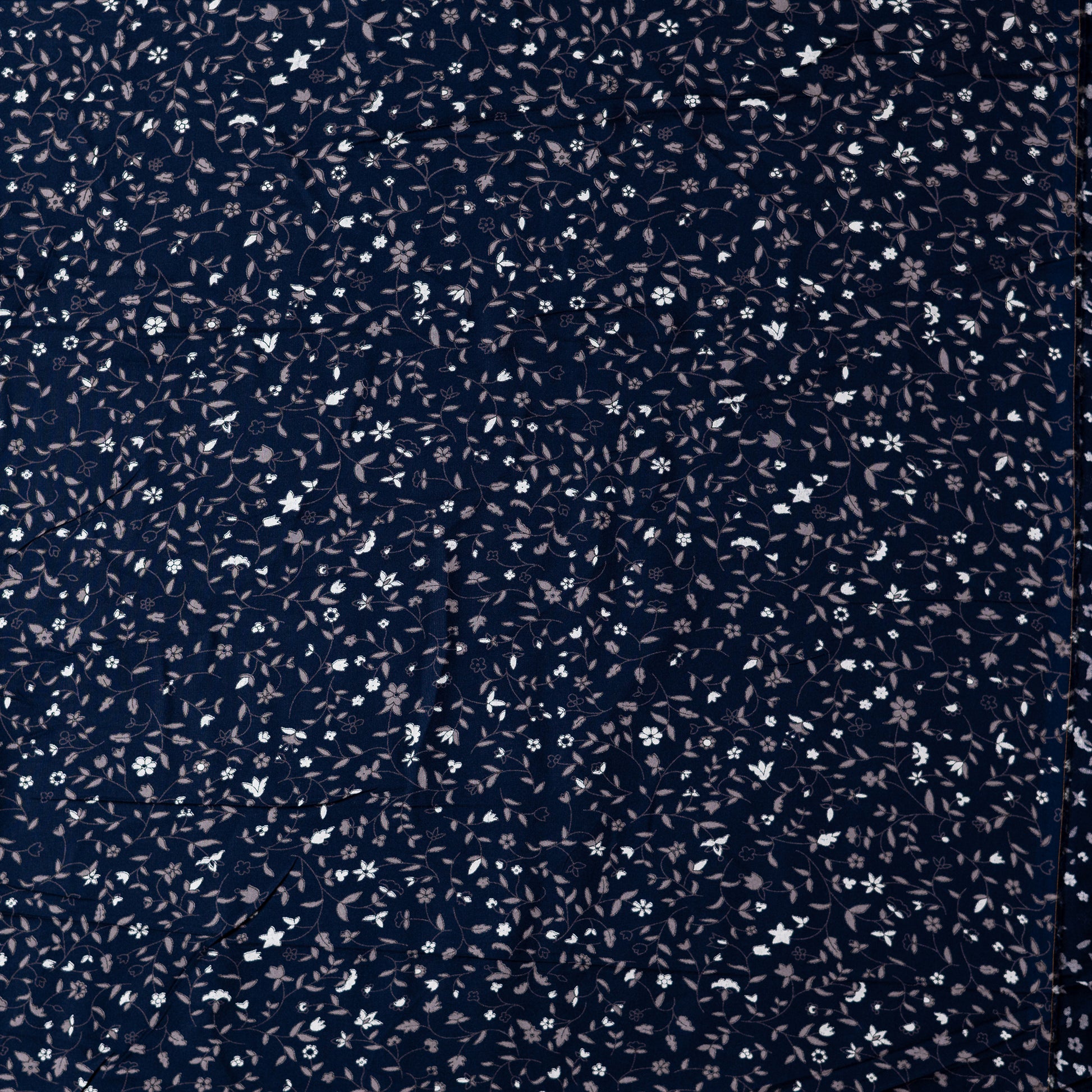 Navy blue color rayon fabric with white and grey color floral prints, this is a small print design elegant fabric