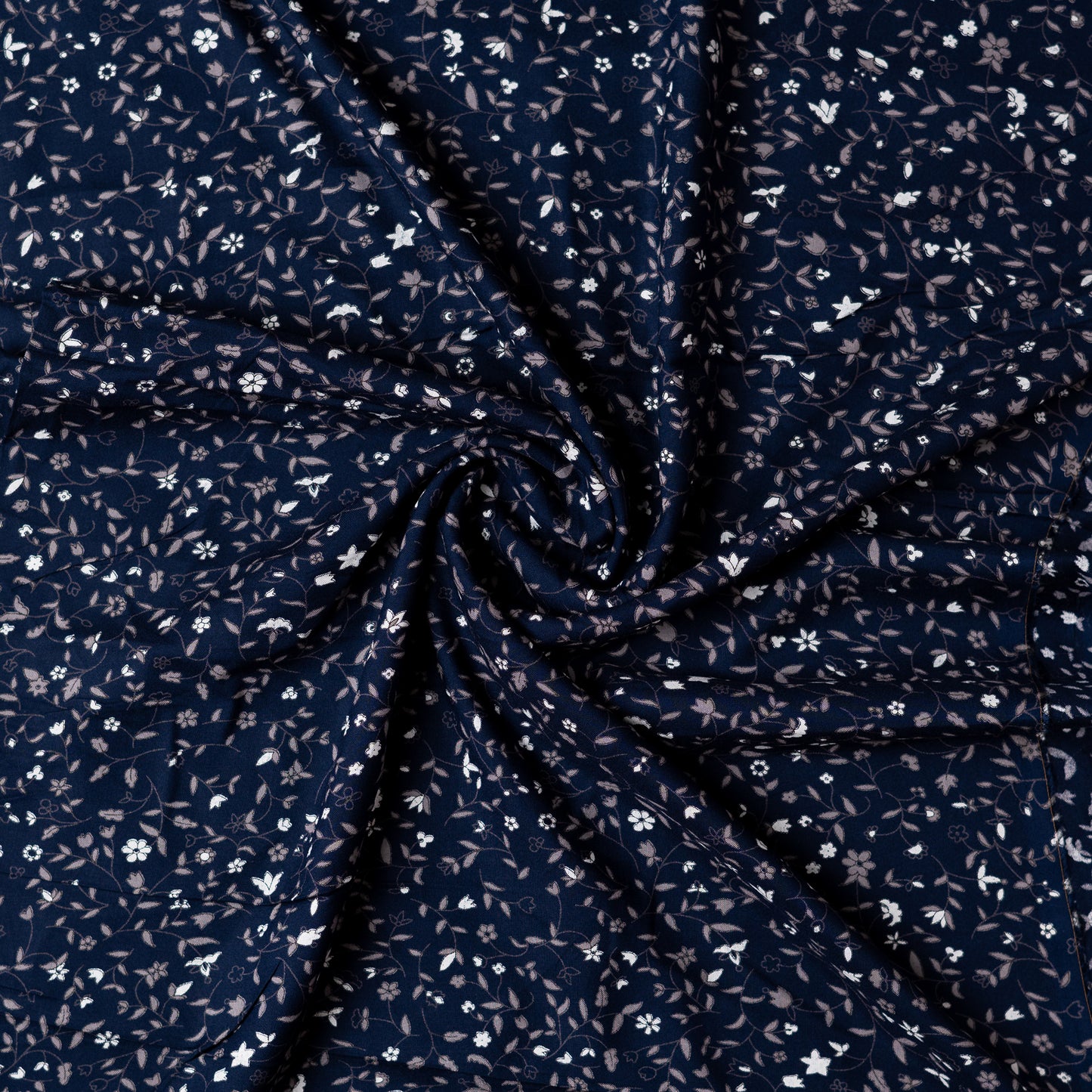 Navy blue color rayon fabric with white and grey color floral prints, this is a small print design elegant fabric
