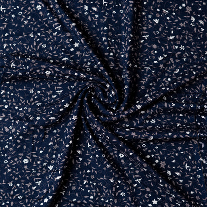 Navy blue color rayon fabric with white and grey color floral prints, this is a small print design elegant fabric