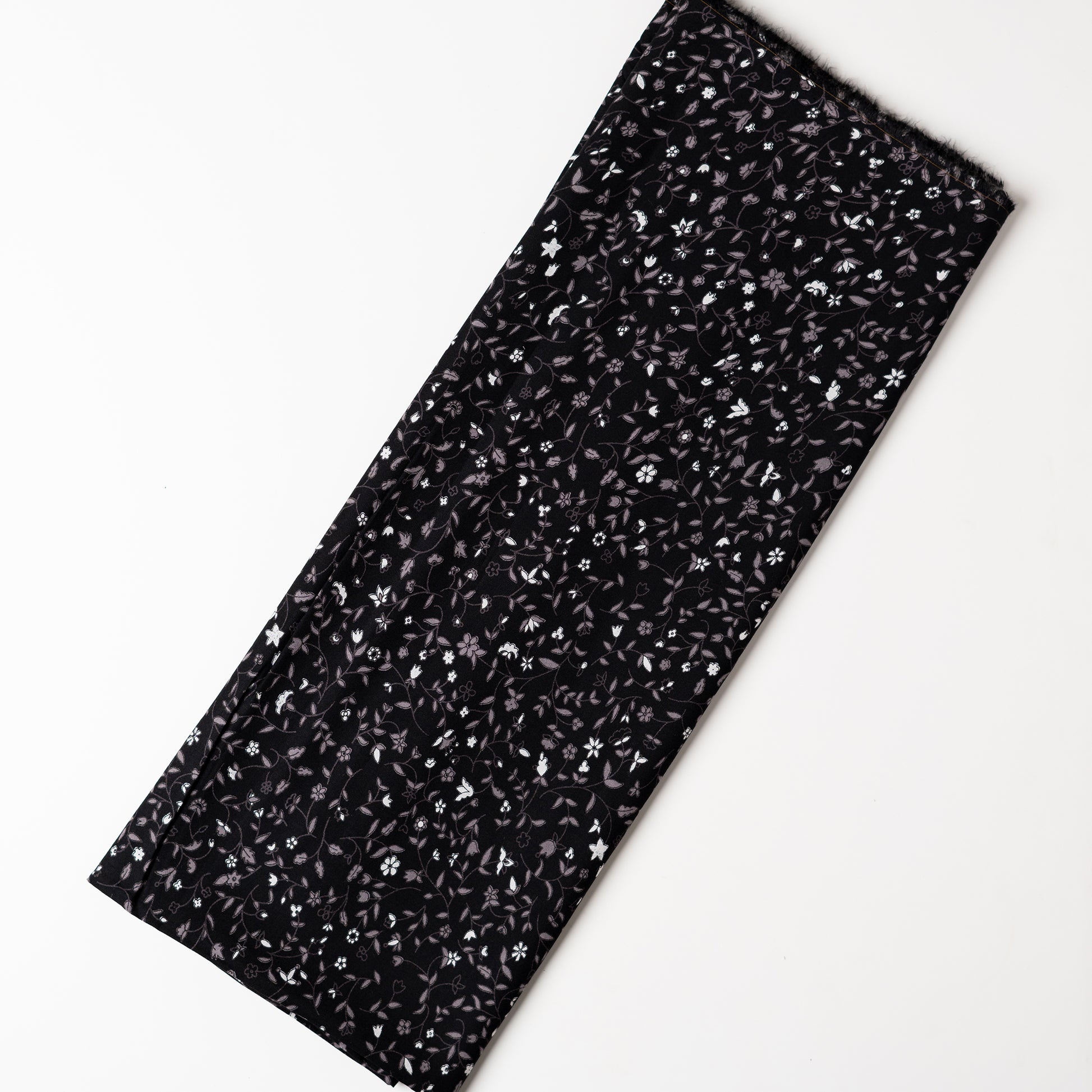 Black color rayon fabric with white and grey color floral prints, this is a small print elegant design.