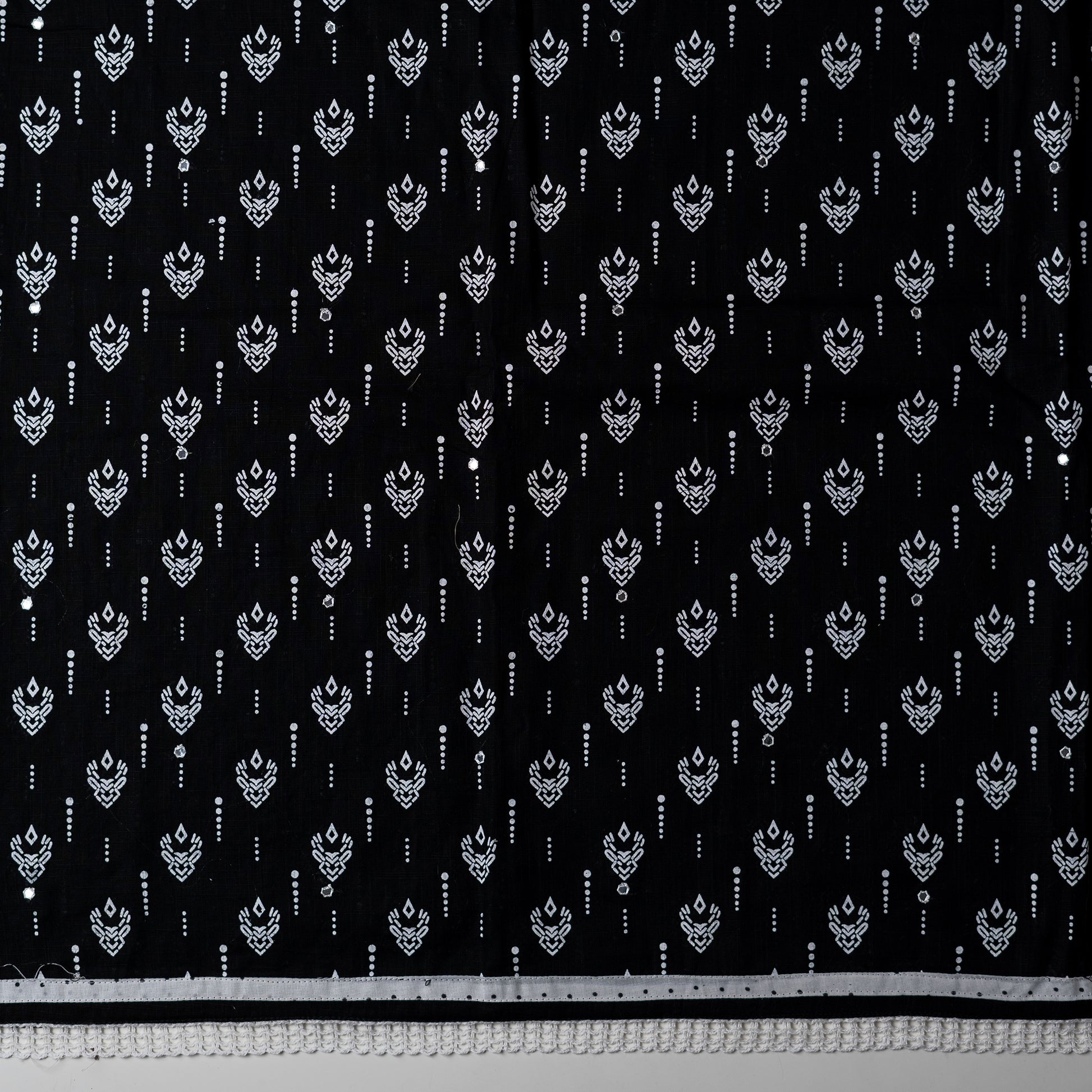 cotton black color top with white color print design and mirror work, it has lace work in the border