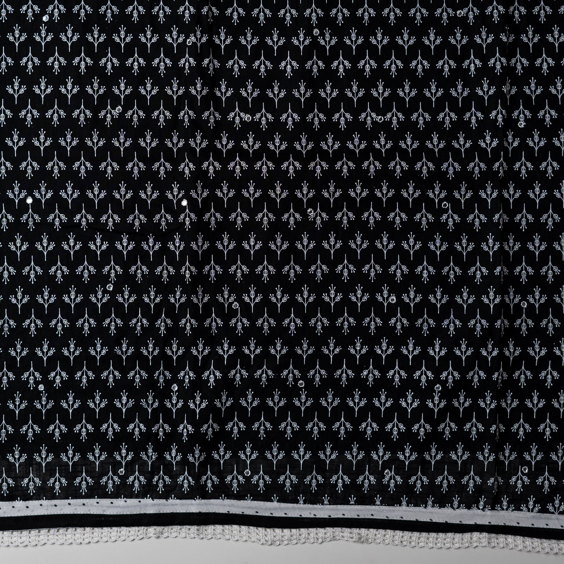 cotton black color top with white color print design and mirror work, it has lace work in the border