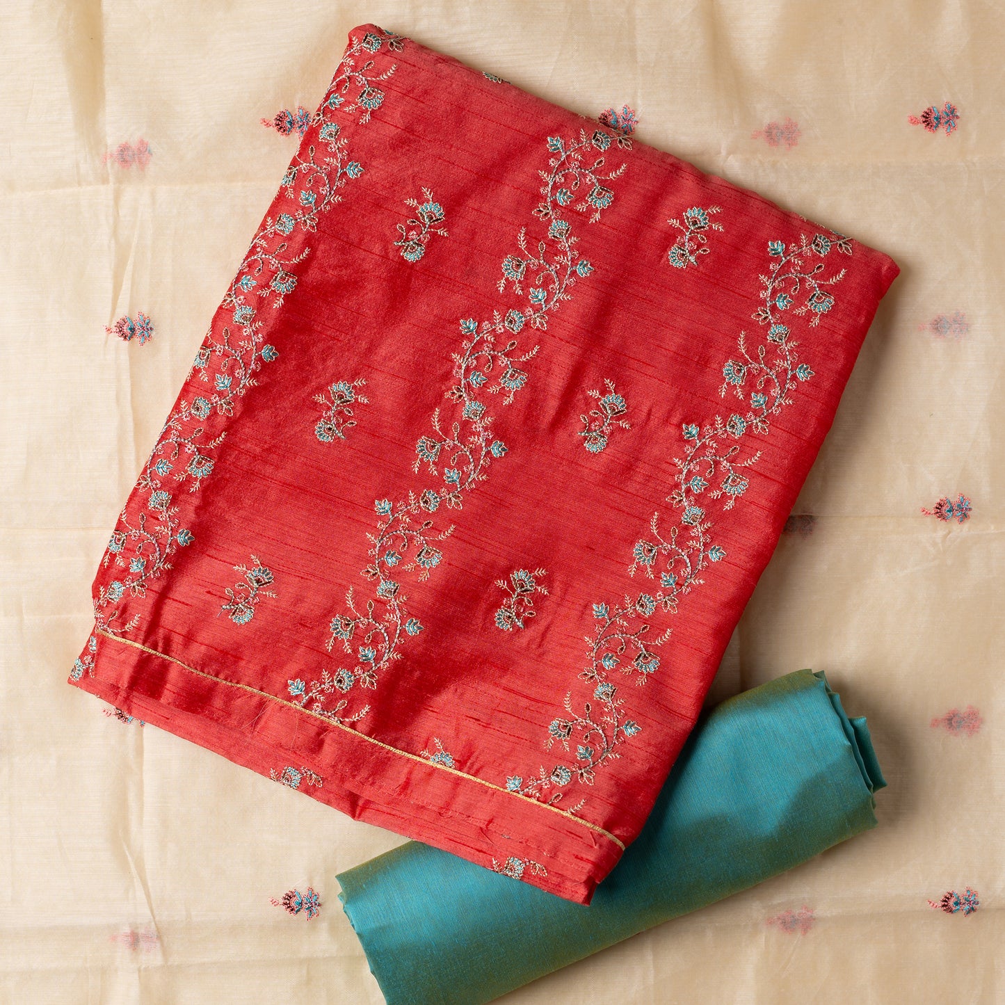 image of dupatta full open and top and bottom in folded style, Unstitched chanderi silk dress material set, pink color chanderi silk top with embroidery work, cream color chanderi silk dupatta with embroidery work, light sky blue color cotton silk bottom