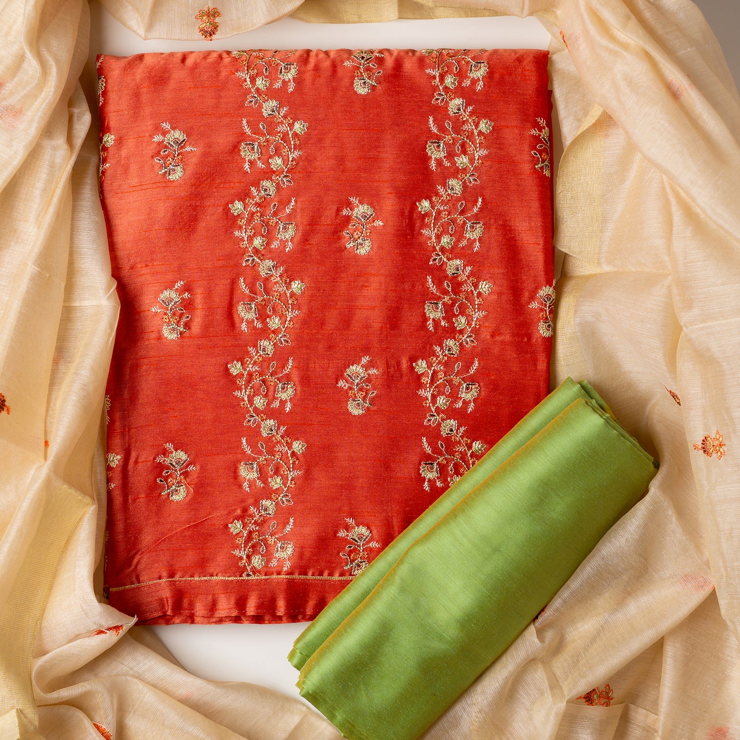 Unstitched chanderi silk dress material set, peach color chanderi silk top with embroidery work, cream color chanderi silk dupatta with embroidery work, parrot green color cotton silk bottom
