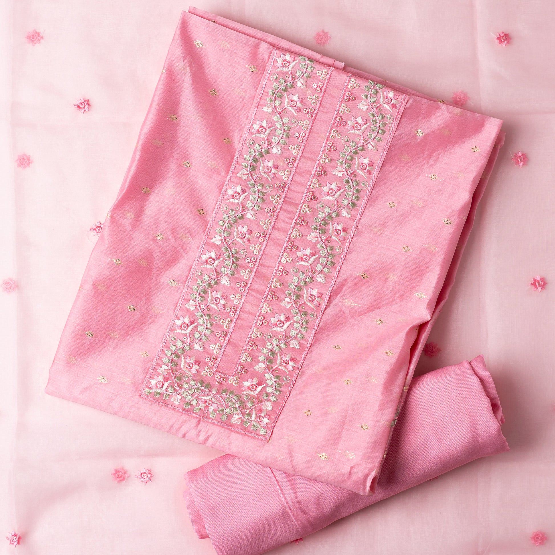 This is one of the best gift for your mom, a beautiful light pink color chanderi silk top with nicely crafted embroidery work in neck line, golden color jacquard weaving all over the body, embroidery work on the border of the dress matching the neck line, it has also golden color sequins work in the border. Beautiful silk dupatta with floral embroidery and the borders are perfectly in sync with the top border, embroidery work and sequins. Plain light pink color soft cotton silk bottom.