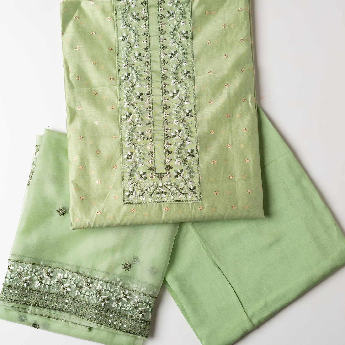 This is one of the best gift for your mom, a beautiful light green color chanderi silk top with nicely crafted embroidery work in neck line, golden color jacquard weaving all over the body, embroidery work on the border of the dress matching the neck line, it has also golden color sequins work in the border. Beautiful silk dupatta with floral embroidery and the borders are perfectly in sync with the top border, embroidery work and sequins. Plain light green color soft cotton silk bottom.