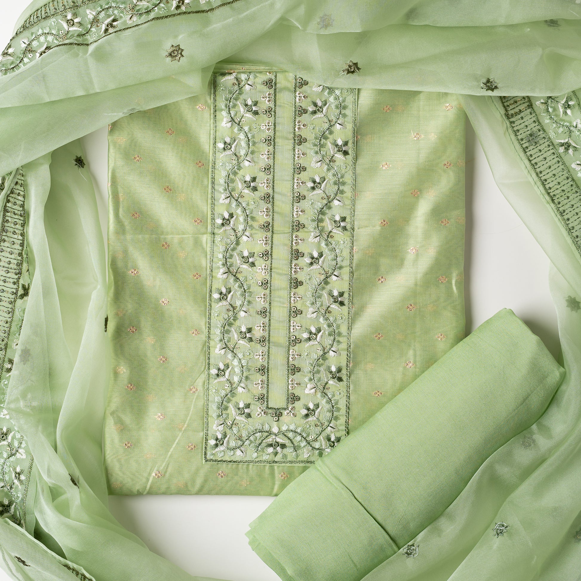 This is one of the best gift for your mom, a beautiful light green color chanderi silk top with nicely crafted embroidery work in neck line, golden color jacquard weaving all over the body, embroidery work on the border of the dress matching the neck line, it has also golden color sequins work in the border. Beautiful silk dupatta with floral embroidery and the borders are perfectly in sync with the top border, embroidery work and sequins. Plain light green color soft cotton silk bottom.