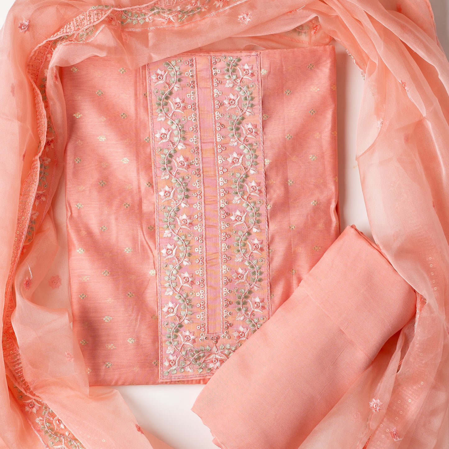 This is one of the best gift for your mom, a beautiful light peach color chanderi silk top with nicely crafted embroidery work in neck line, golden color jacquard weaving all over the body, embroidery work on the border of the dress matching the neck line, it has also golden color sequins work in the border. Beautiful silk dupatta with floral embroidery and the borders are perfectly in sync with the top border, embroidery work and sequins. Plain light peach color soft cotton silk bottom