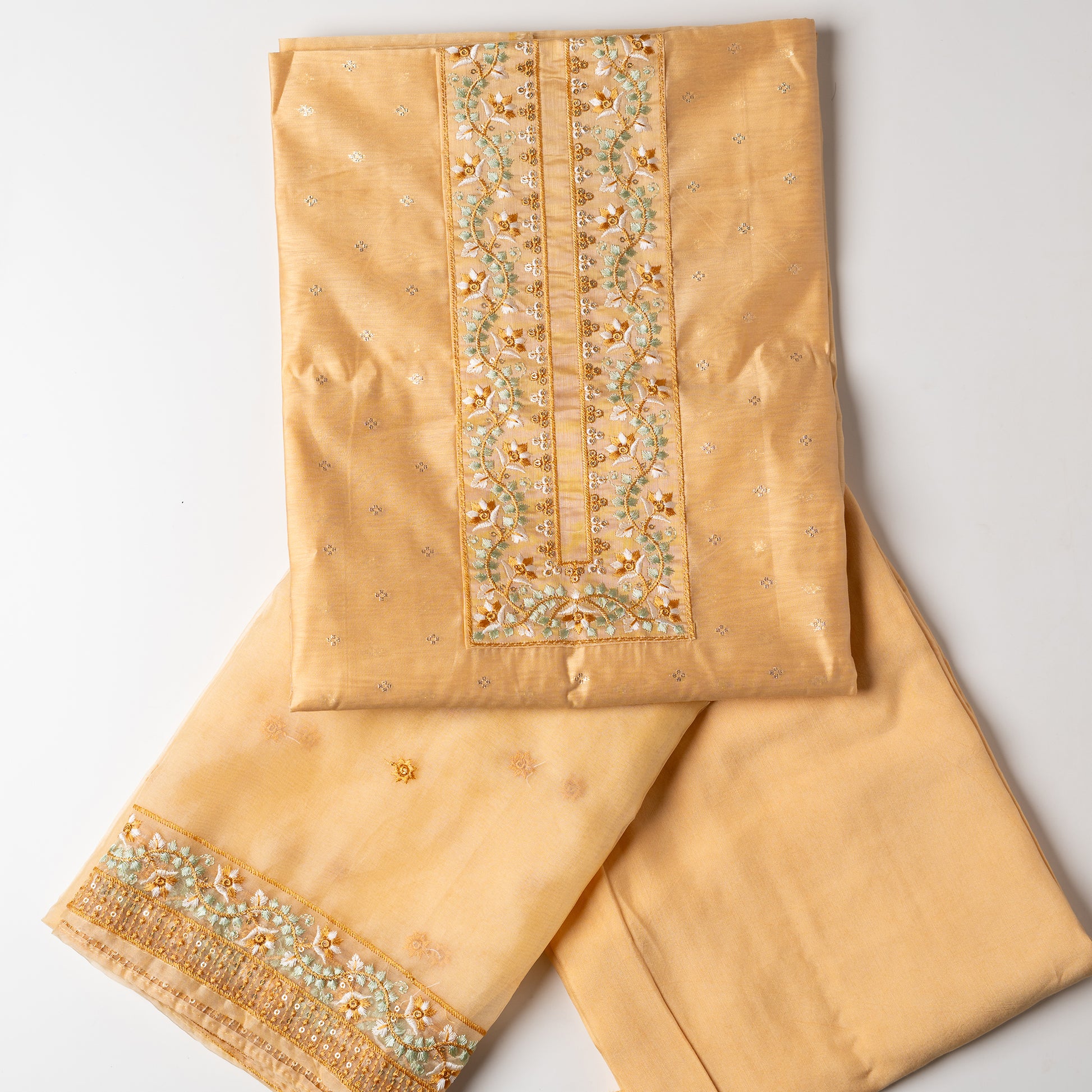 This is one of the best gift for your mom, a beautiful light golden yellow color chanderi silk top with nicely crafted embroidery work in neck line, golden color jacquard weaving all over the body, embroidery work on the border of the dress matching the neck line, it has also golden color sequins work in the border. Beautiful silk dupatta with floral embroidery and the borders are perfectly in sync with the top border, embroidery work and sequins. Plain light golden yellow color soft cotton silk bottom.