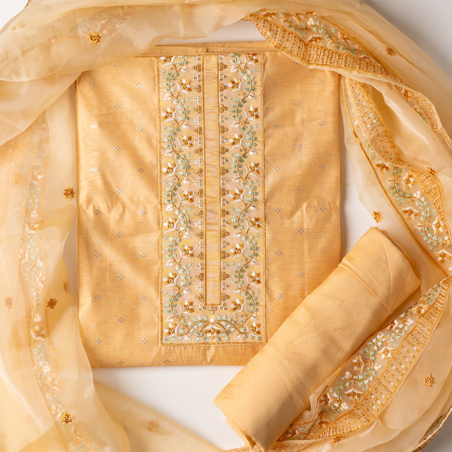 This is one of the best gift for your mom, a beautiful light golden yellow color chanderi silk top with nicely crafted embroidery work in neck line, golden color jacquard weaving all over the body, embroidery work on the border of the dress matching the neck line, it has also golden color sequins work in the border. Beautiful silk dupatta with floral embroidery and the borders are perfectly in sync with the top border, embroidery work and sequins. Plain light golden yellow color soft cotton silk bottom.