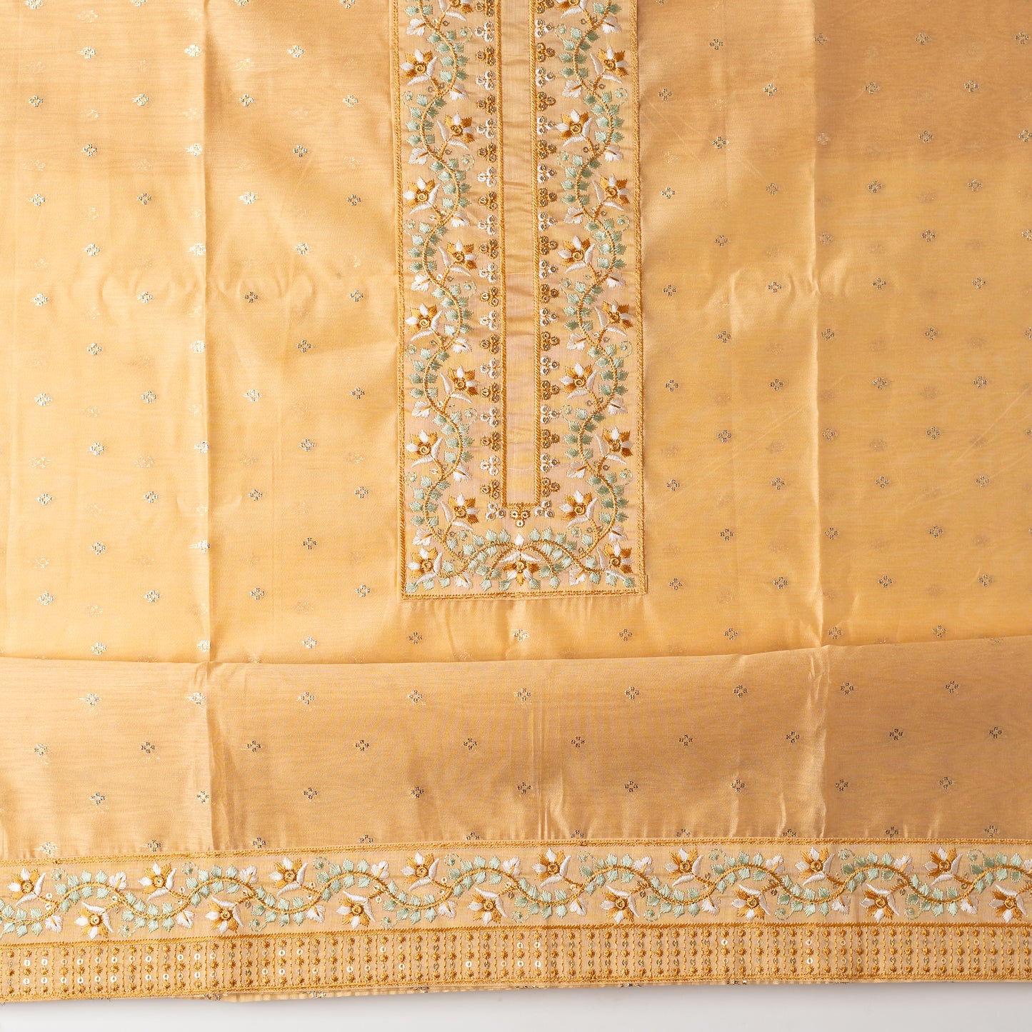 chanderi silk top with nicely crafted embroidery work in neck line, golden color jacquard weaving all over the body, embroidery work on the border of the dress matching the neck line, it has also golden color sequins work in the border