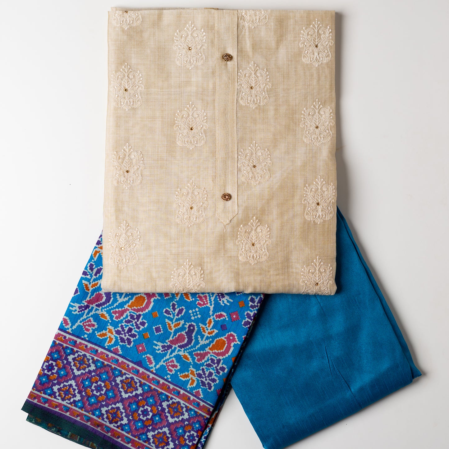 Chanderi silk dress material with embroidery and sequins work, the embroidery work is done with the same color thread of the top which gives a very elegant look. The top has show buttons and golden color piping in the border colorful digital printed silk dupatta , teal blue color cotton silk bottom.