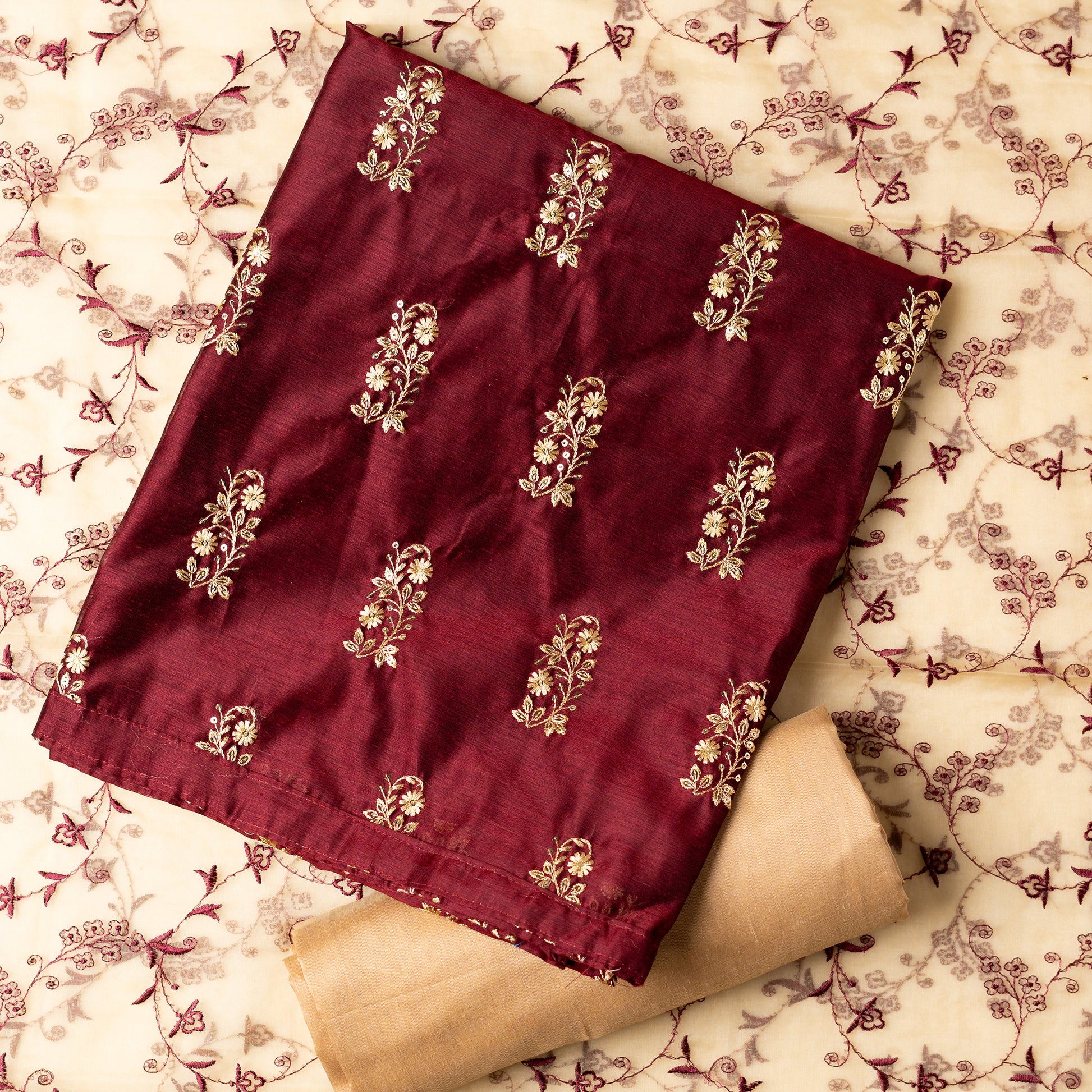 This beautiful chanderi silk dress material set will suit you for any of your functions, be it evening party, bridal wear, birthday party or anniversary gift. Maroon color top with elegent embroidery and sequins work. Cream color silk dupatta with matching maroon color embroidery work is giving the set a perfect party wear look. Cotton silk cream color border.
