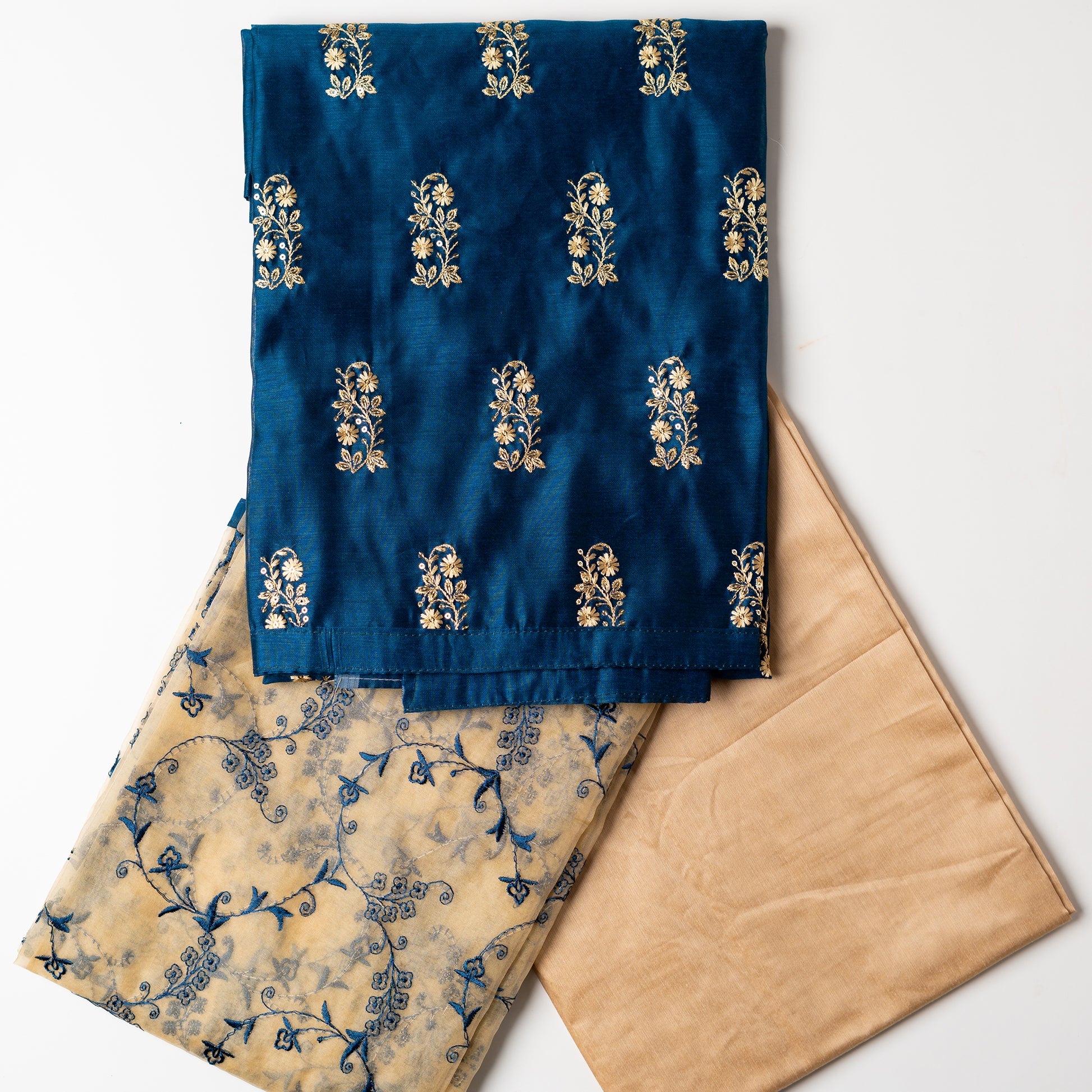 This beautiful chanderi silk dress material set will suit you for any of your functions, be it evening party, bridal wear, birthday party or anniversary gift. Blue color top with elegant embroidery and sequins work. Cream color silk dupatta with matching blue color embroidery work is giving the set a perfect party wear look. Cotton silk cream color border.