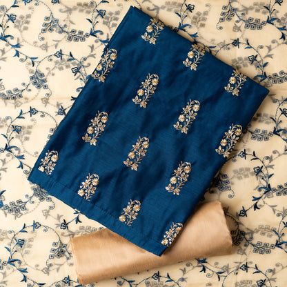 This beautiful chanderi silk dress material set will suit you for any of your functions, be it evening party, bridal wear, birthday party or anniversary gift. Blue color top with elegant embroidery and sequins work. Cream color silk dupatta with matching blue color embroidery work is giving the set a perfect party wear look. Cotton silk cream color border.