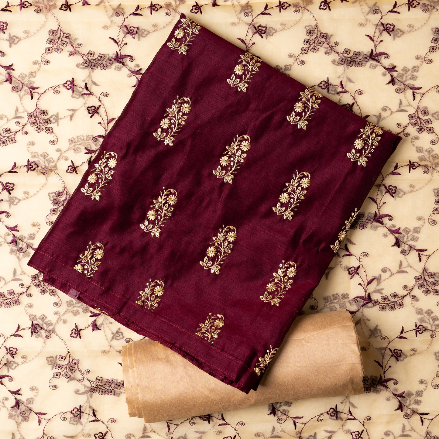 This beautiful chanderi silk dress material set will suit you for any of your functions, be it evening party, bridal wear, birthday party or anniversary gift. Wine color top with elegant embroidery and sequins work. Cream color silk dupatta with matching wine color embroidery work is giving the set a perfect party wear look. Cotton silk cream color border.