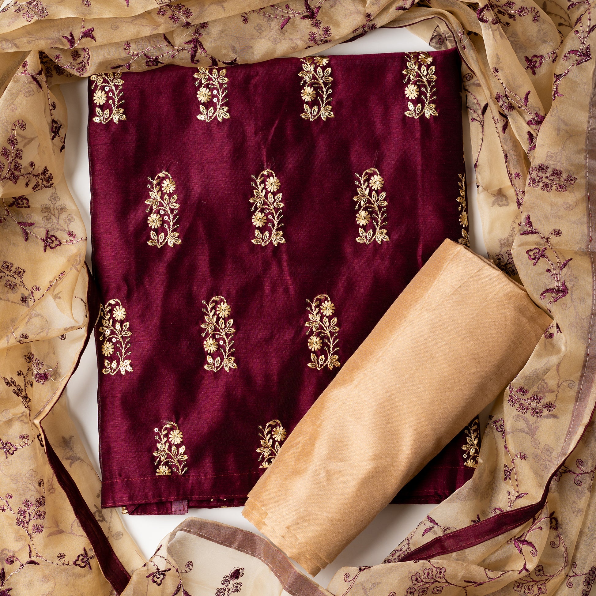 This beautiful chanderi silk dress material set will suit you for any of your functions, be it evening party, bridal wear, birthday party or anniversary gift. Wine color top with elegant embroidery and sequins work. Cream color silk dupatta with matching wine color embroidery work is giving the set a perfect party wear look. Cotton silk cream color border.