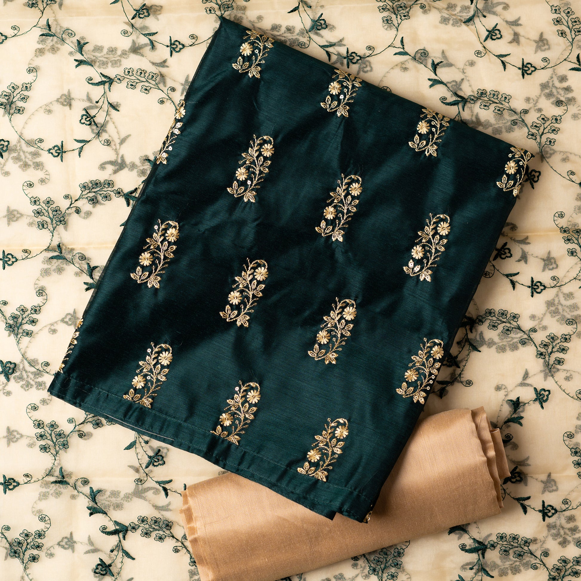 This beautiful chanderi silk dress material set will suit you for any of your functions, be it evening party, bridal wear, birthday party or anniversary gift. Green color top with elegant embroidery and sequins work. Cream color silk dupatta with matching green color embroidery work is giving the set a perfect party wear look. Cotton silk cream color border