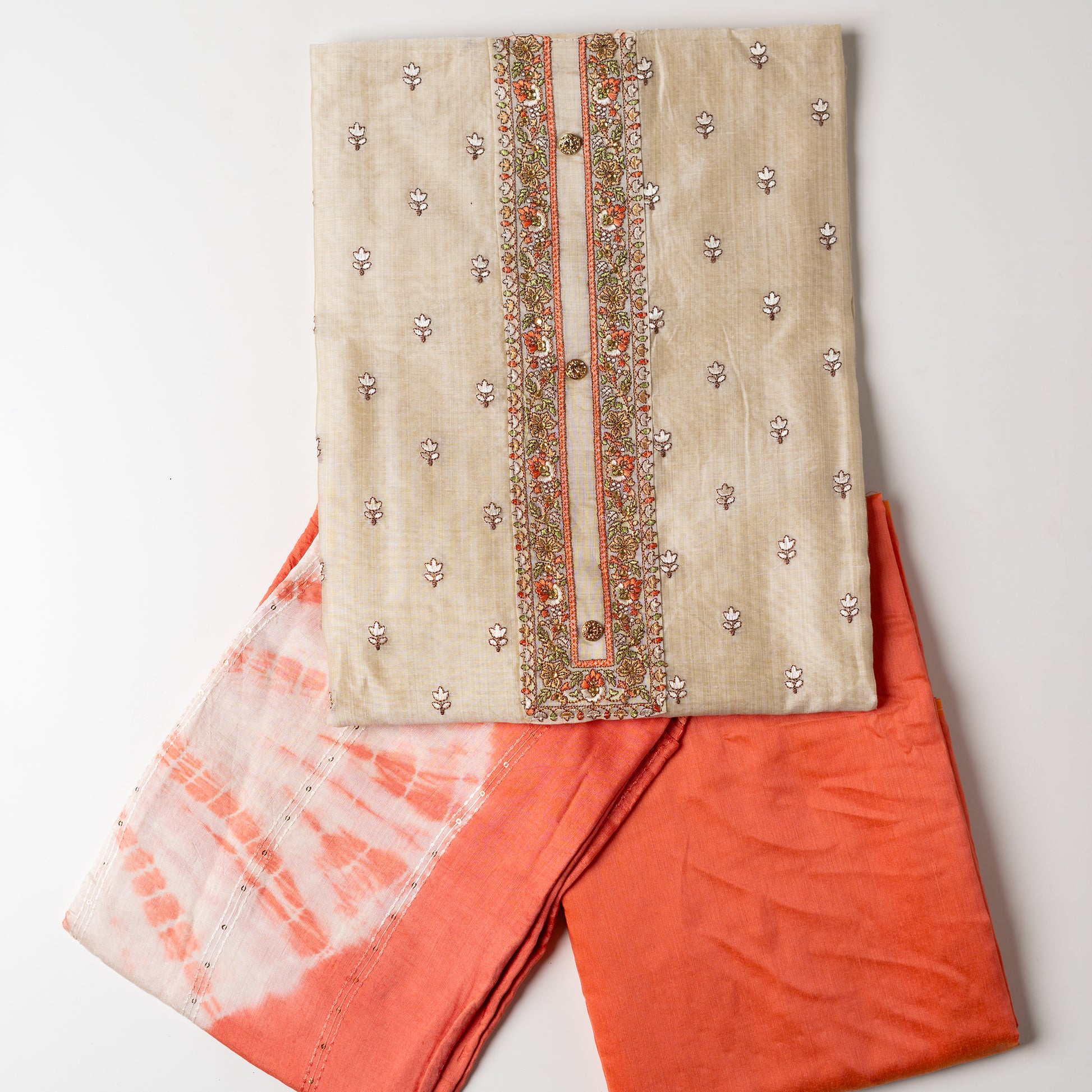 Chanderi silk unstitched dress material set, Ivory color Chanderi Silk top with floral embroidery all over the body in the front and elegant peach color embroidery work in neck line with show buttons. cotton peach color plain bottom. Peach and cream color silk dupatta with sequins and thread