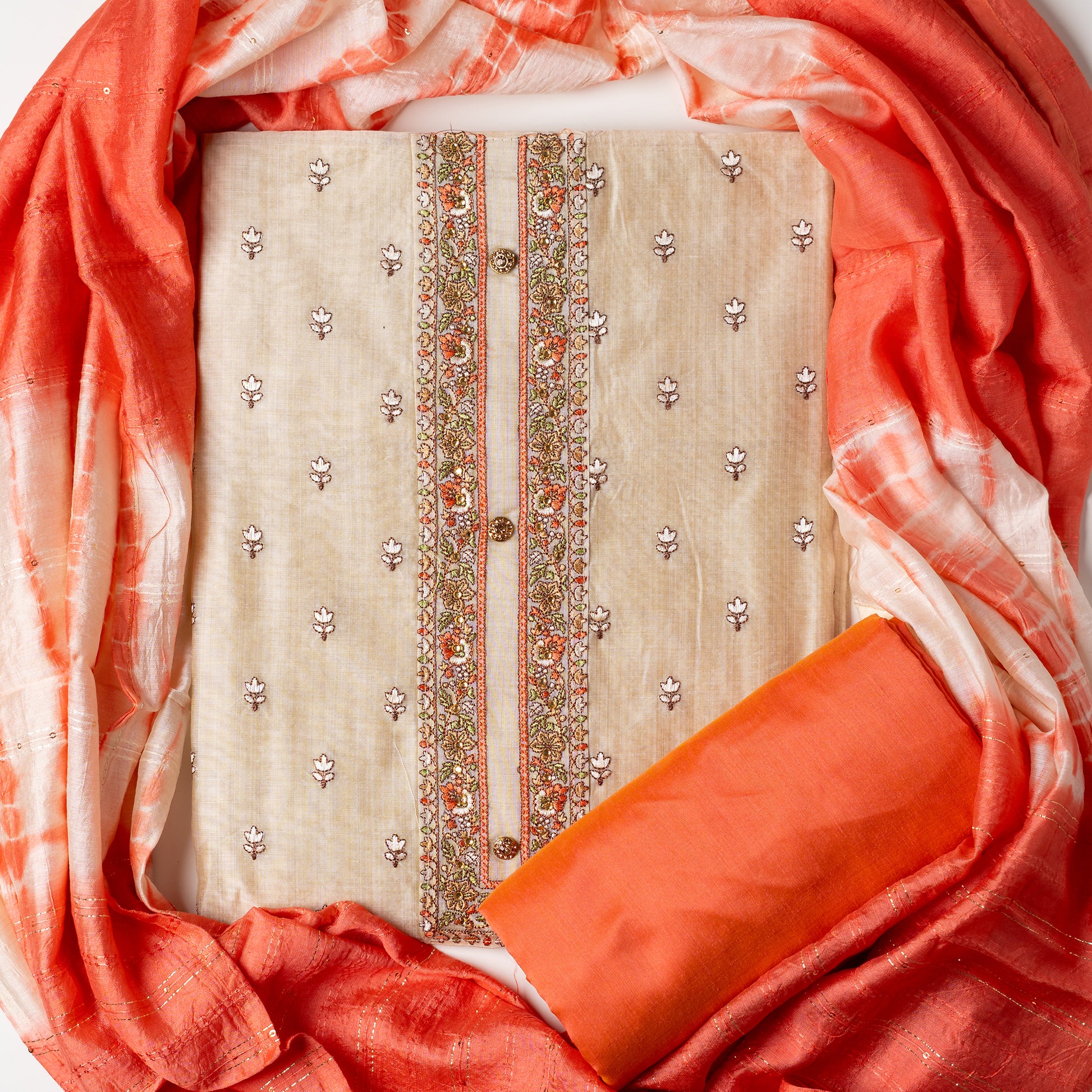 Chanderi silk unstitched dress material set, Ivory color Chanderi Silk top with floral embroidery all over the body in the front and elegant peach color embroidery work in neck line with show buttons. cotton peach color plain bottom. Peach and cream color silk dupatta with sequins and thread