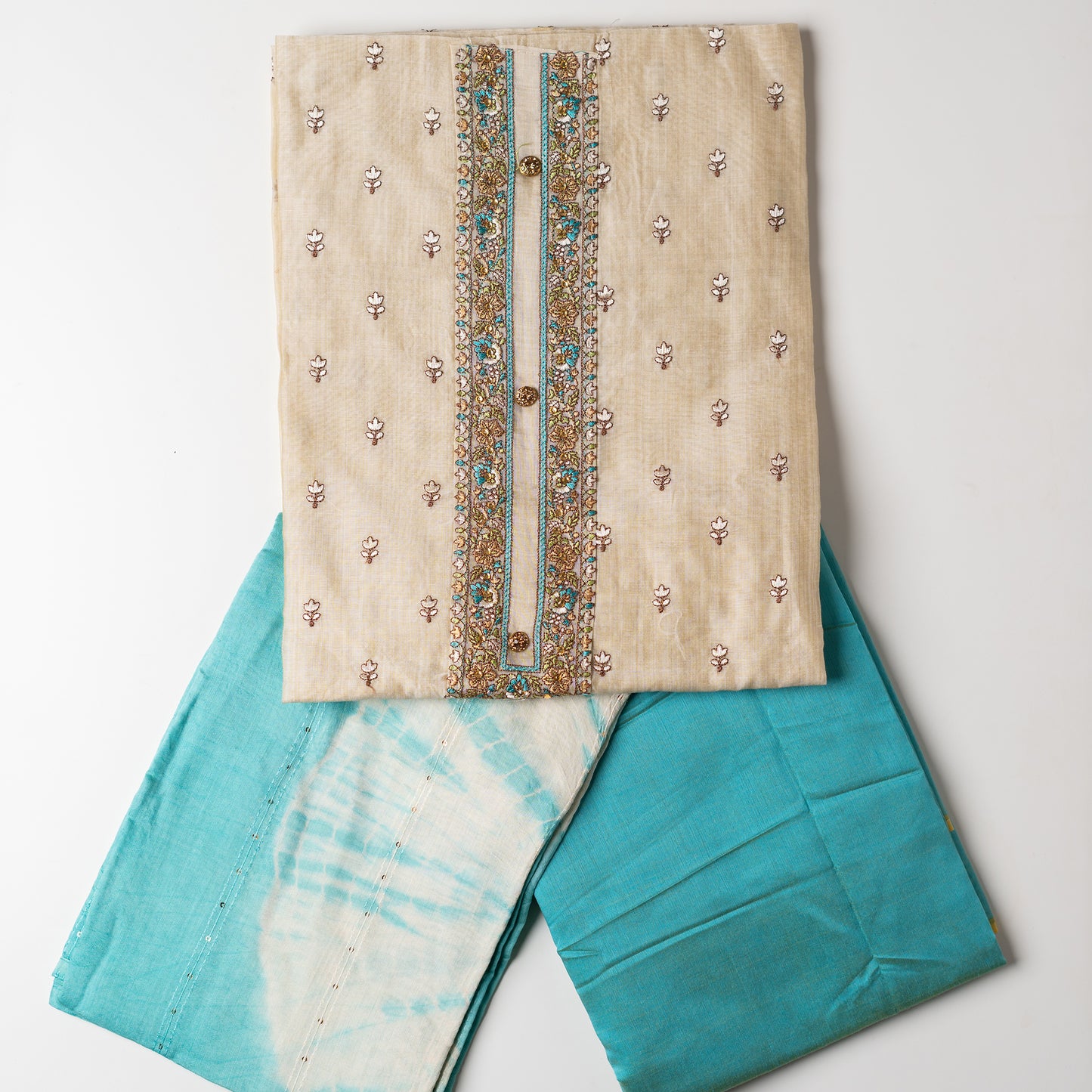 churidhar material set, Ivory color Chanderi Silk top with floral embroidery all over the body in the front and elegant sea green color embroidery work in neck line with show buttons. cotton sea green color plain bottom. Sea green and cream color silk dupatta with sequins and thread work 
