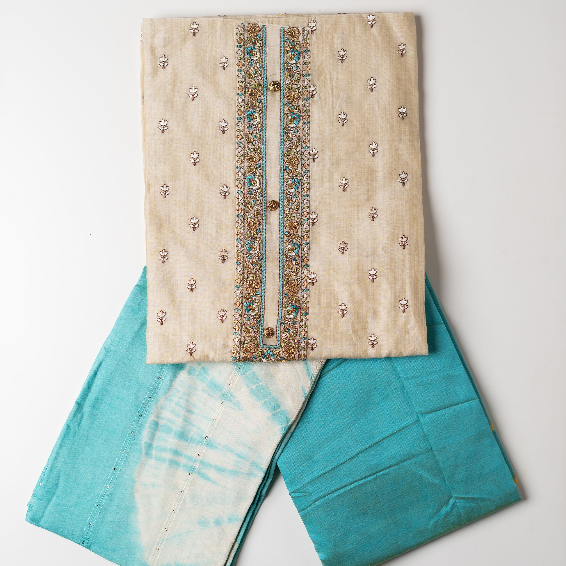 churidhar material set, Ivory color Chanderi Silk top with floral embroidery all over the body in the front and elegant sea green color embroidery work in neck line with show buttons. cotton sea green color plain bottom. Sea green and cream color silk dupatta with sequins and thread work
