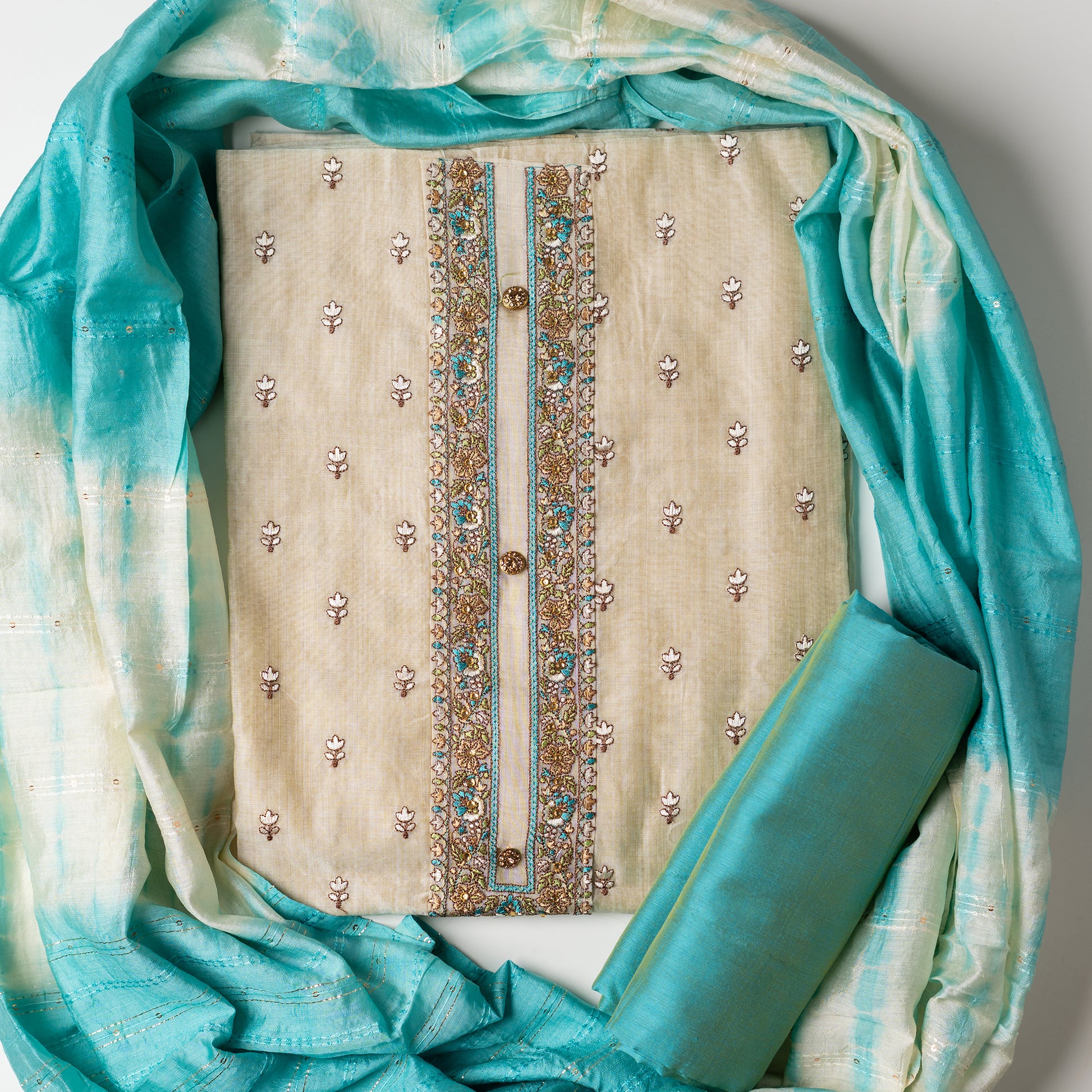 churidhar material set, Ivory color Chanderi Silk top with floral embroidery all over the body in the front and elegant sea green color embroidery work in neck line with show buttons. cotton sea green color plain bottom. Sea green and cream color silk dupatta with sequins and thread work 
