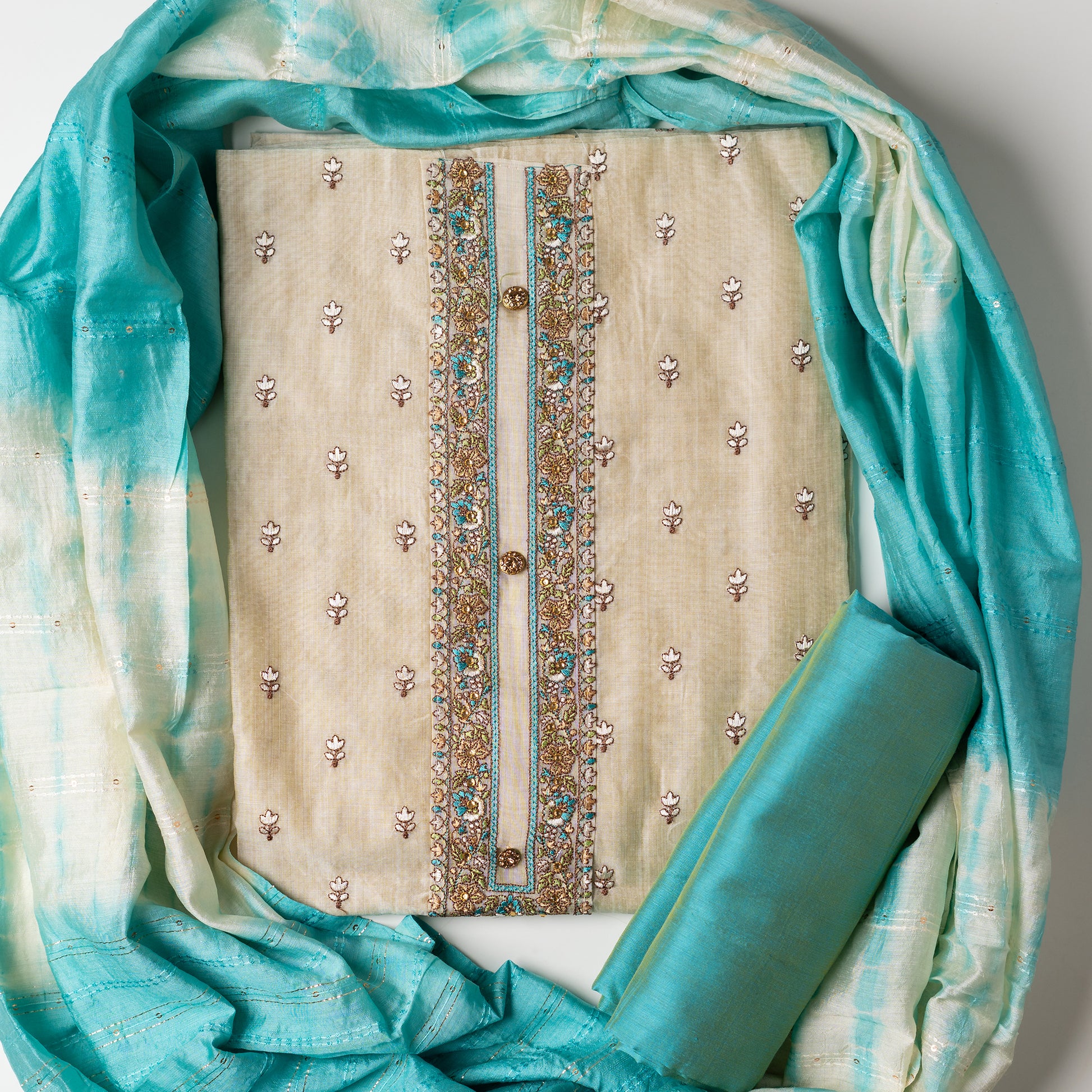churidhar material set, Ivory color Chanderi Silk top with floral embroidery all over the body in the front and elegant sea green color embroidery work in neck line with show buttons. cotton sea green color plain bottom. Sea green and cream color silk dupatta with sequins and thread work