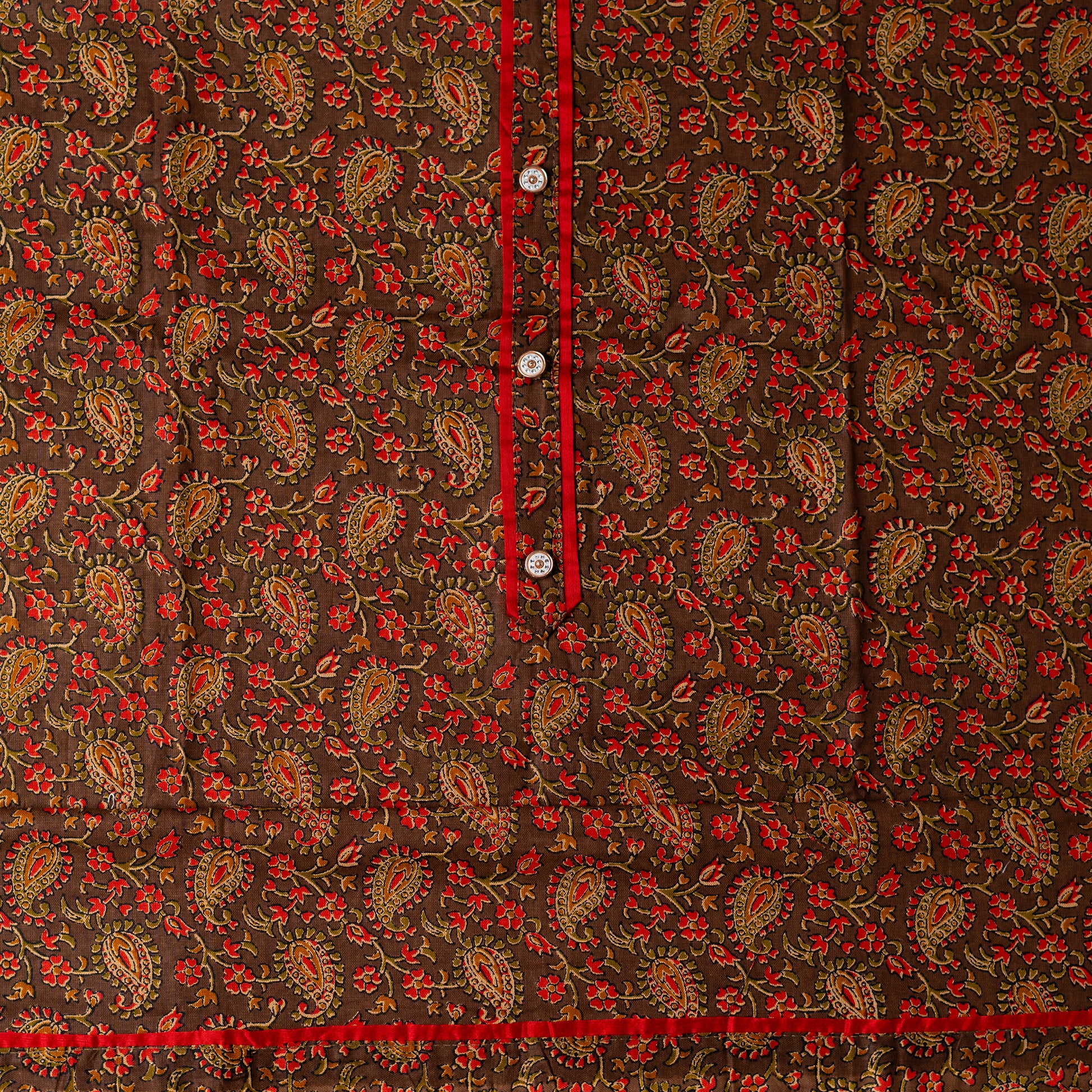 cotton top material with brown color base and multi color beautiful print design, it has show buttons in the neck area and also red color piping in the border