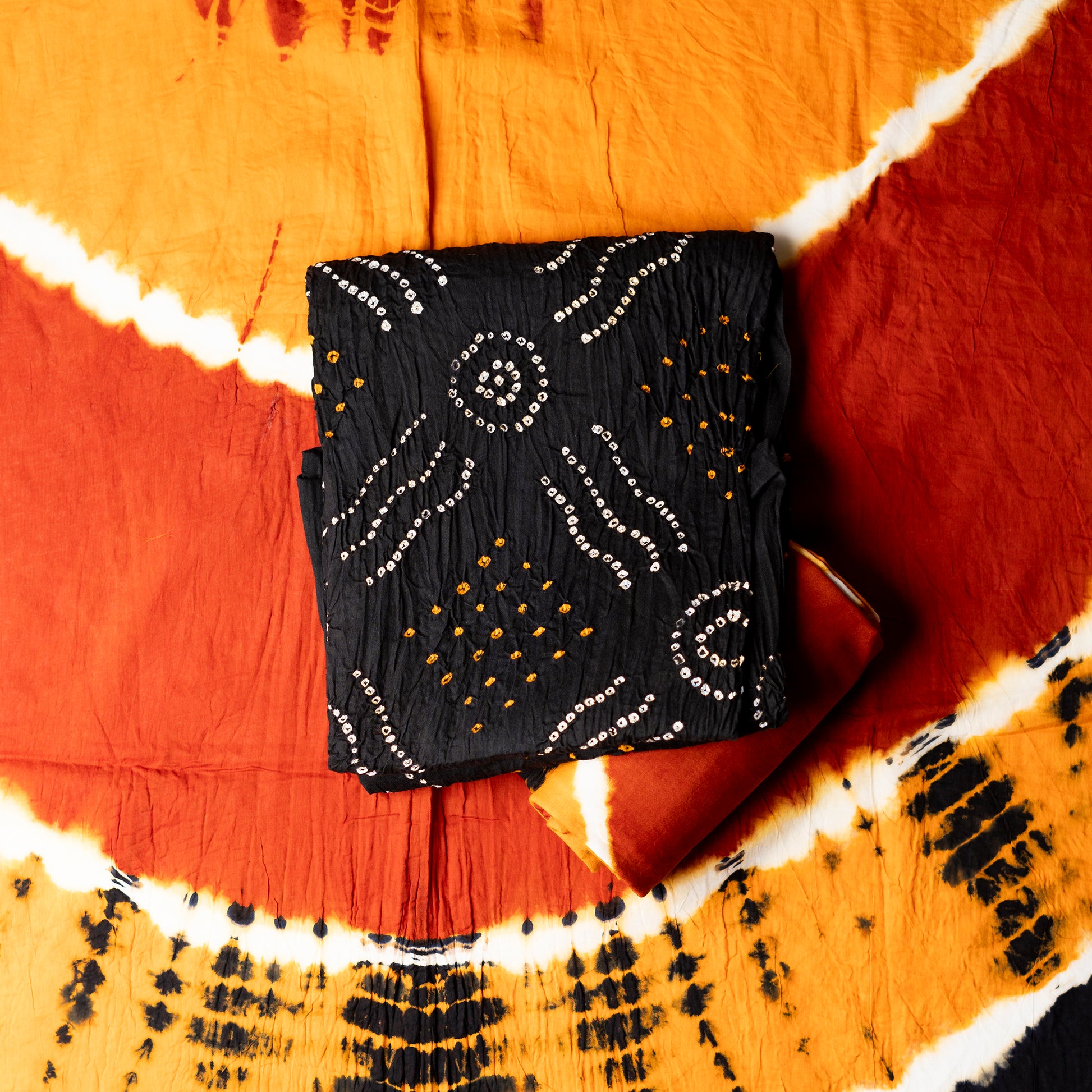 Black color cotton bandhani top with yellow and white color bandhej designs, multi color shibori print design bottom and dupatta