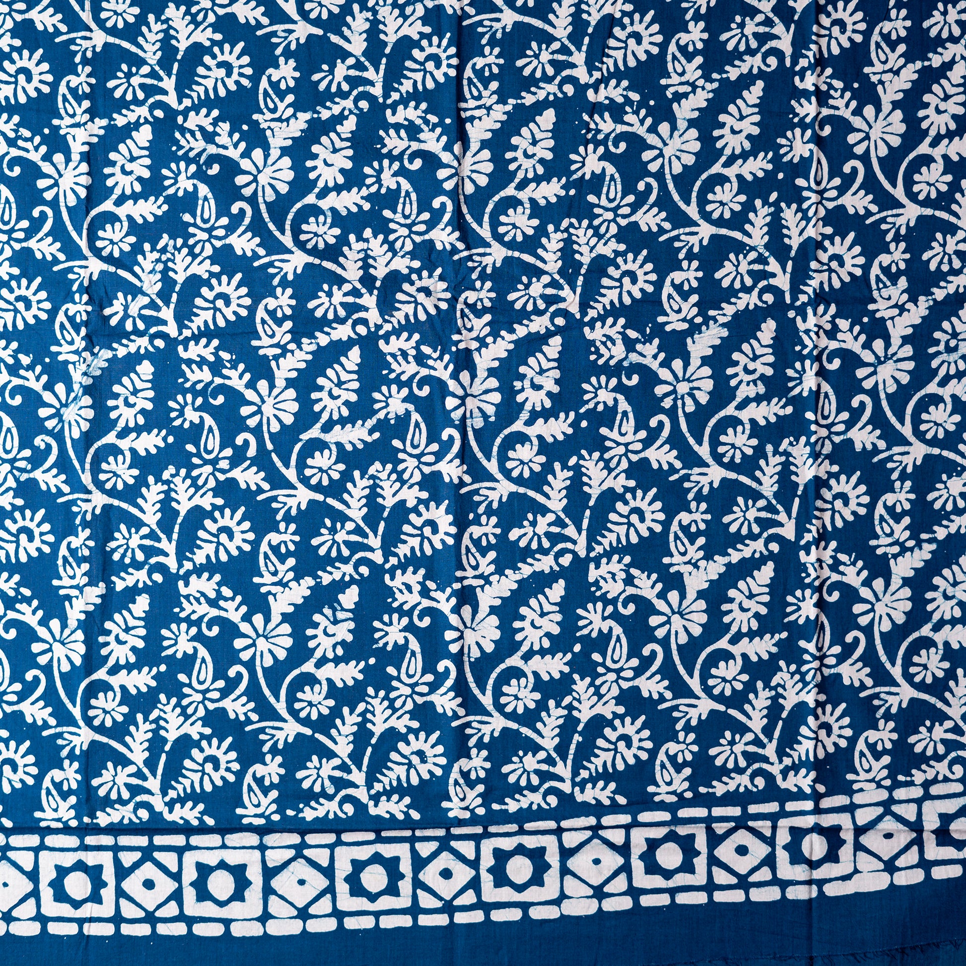 Cotton blue color wax batik dress material with white prints. 