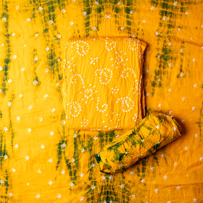 yellow color bandhani top with white bandhej designs, yellow color bottom with green shibori design prints and white bandhej designs, yellow color dupatta with green color shibori print designs and white bandhej designs