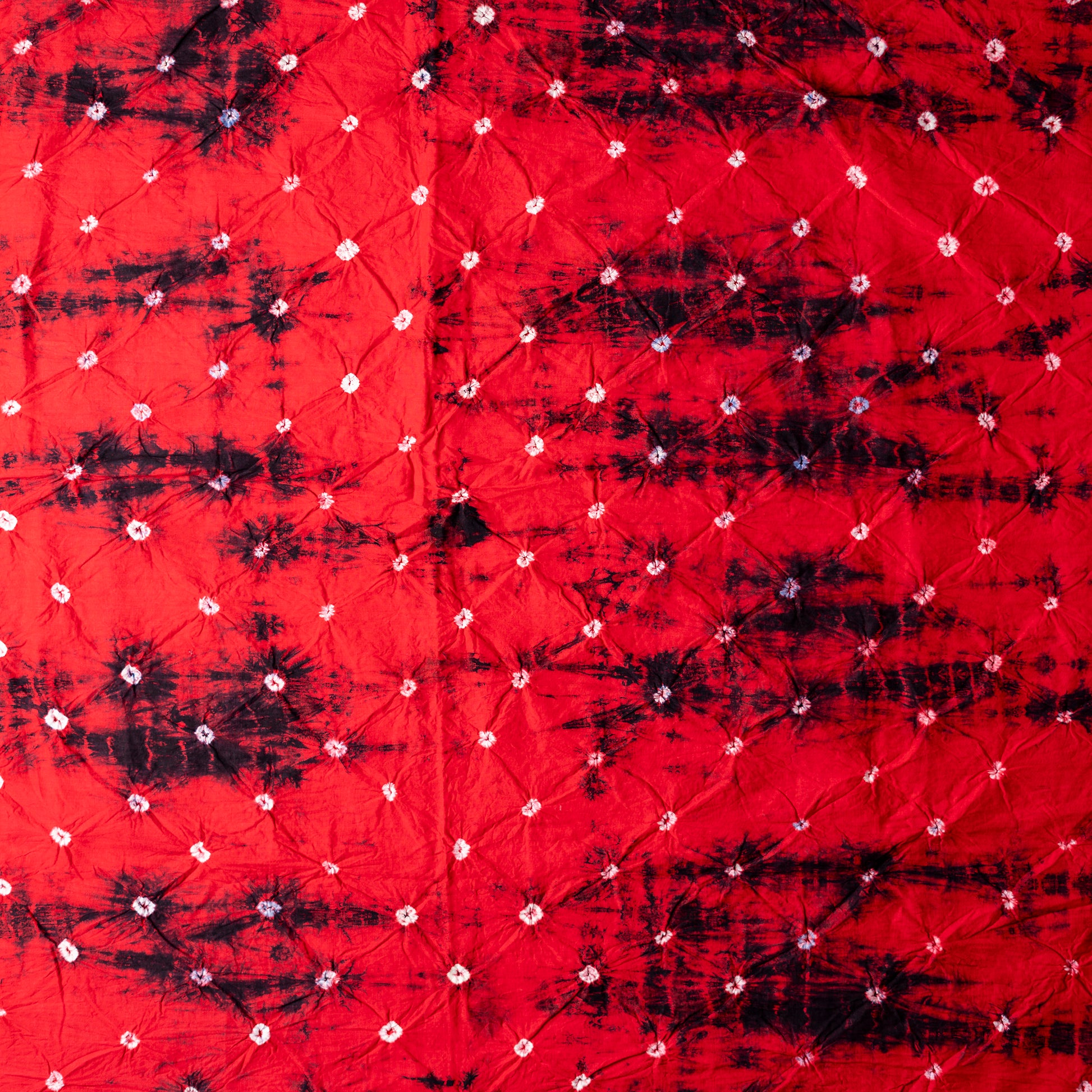 Red color bottom with shibori designs in black.