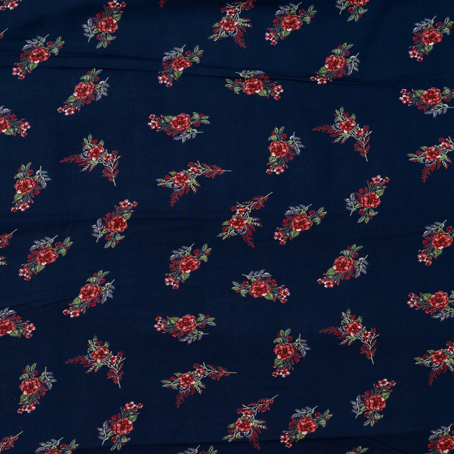 Navy blue color rayon printed fabric with floral designs in maroon and green color