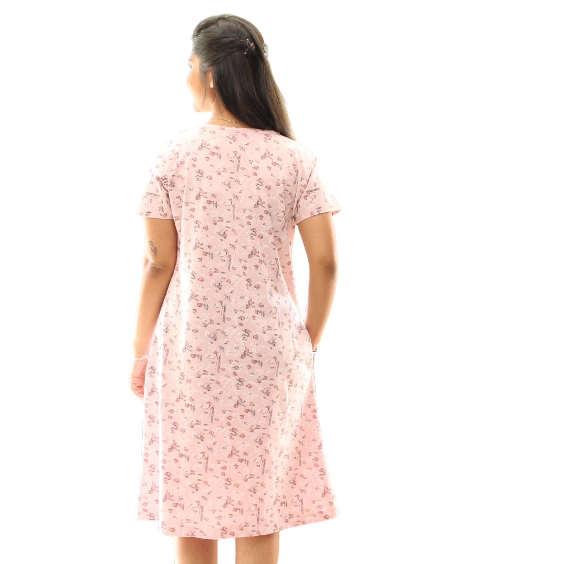 women wearing cotton short nighty in light pink color with all over small prints, standing showing the backside view
