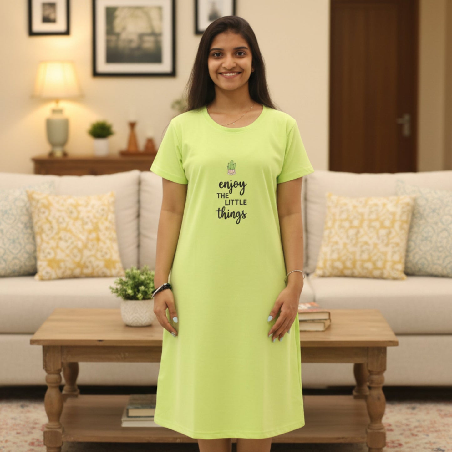 Woman wearing a parrot green cotton short nighty with graphic design in front 